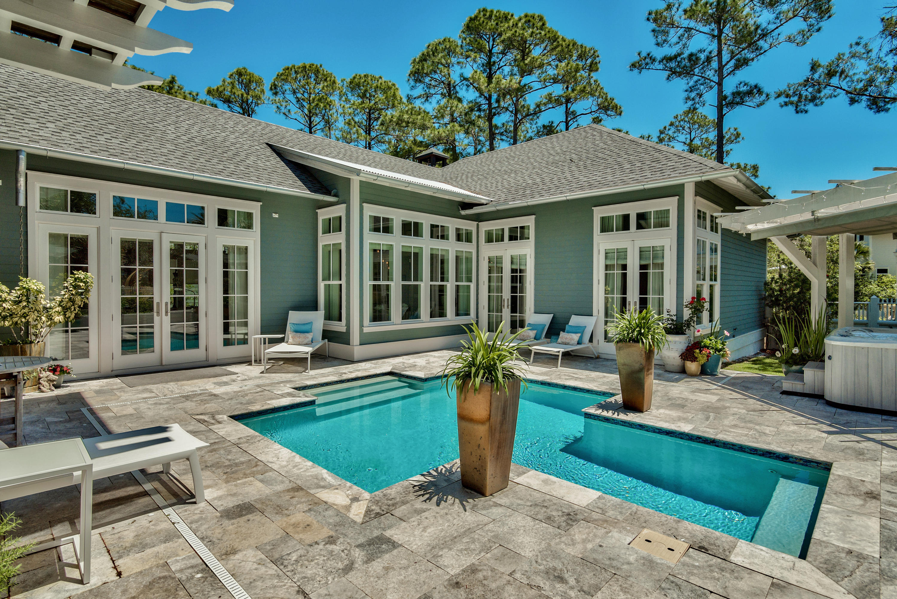 This gorgeous, one of a kind custom home is the beach retreat you have been waiting for! Located in the private gated community of Watersound West Beach, you will enjoy access to one of 30a's premier secluded beaches through Deer Lake State Park. The main entrance to the home leads you through a courtyard to the beautiful outdoor living area which includes a saltwater pool, an arbored hot tub, outdoor kitchen area, and lovely guest quarters. Just off the pool area are french doors to the main house which boasts 12 foot ceilings throughout the first floor. The living area features a gas fireplace and is open to the kitchen and dining room. The kitchen is a chef's dream and has two islands, ice maker, two wine coolers, gas range, and more! There is a beautiful and spacious master suite on the main level with an exquisite master bath, two custom walk-in closets, and french doors to the pool. Just down the hall from the master is a spacious study/den with french doors to the screened porch with wood burning fireplace. A beautiful powder bath, large custom laundry room, and an extra-large storage pantry complete the main level. The second level includes two bedroom suites (one has a balcony overlooking the pool) and a media/family room all with beautiful hardwood floors. Another great feature of this home is the garage---it has 10 foot garage doors and a "lift" so it will accommodate 3 cars! Some other special features of the home include remote control blinds, central vacuum, large fenced yard, an abundance of storage, and it is located close to the community pool, park, and beach access. Home is beautifully situated on one of the largest lots in the neighborhood and backs up to green space adjacent to Deer Lake State Park. Watersound West Beach features a community pool/clubhouse, parks, boardwalks, security/gate, private boardwalk to the beach, and fitness center at Watersound Beach.