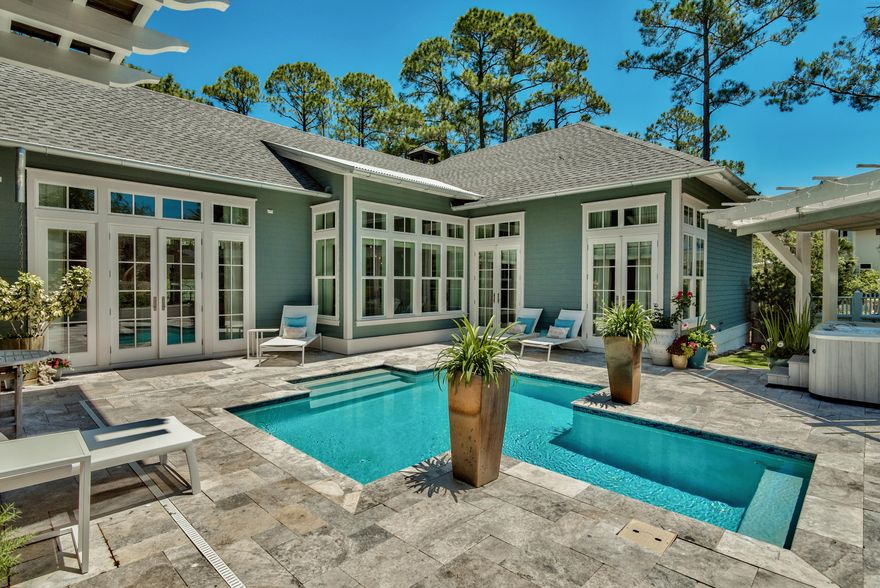 This gorgeous, one of a kind custom home is the beach retreat you have been waiting for! Located in the private gated community of Watersound West Beach, you will enjoy access to one of 30a's premier secluded beaches through Deer Lake State Park. The main entrance to the home leads you through a courtyard to the beautiful outdoor living area which includes a saltwater pool, an arbored hot tub, outdoor kitchen area, and lovely guest quarters. Just off the pool area are french doors to the main house which boasts 12 foot ceilings throughout the first floor. The living area features a gas fireplace and is open to the kitchen and dining room. The kitchen is a chef's dream and has two islands, ice maker, two wine coolers, gas range, and more! There is a beautiful and spacious master suite on the main level with an exquisite master bath, two custom walk-in closets, and french doors to the pool.  Just down the hall from the master is a spacious study/den with french doors to the screened porch with wood burning fireplace.  A beautiful powder bath, large custom laundry room, and an extra-large storage pantry complete the main level.  The second level includes two bedroom suites (one has a balcony overlooking the pool) and a media/family room all with beautiful hardwood floors.  Another great feature of this home is the garage---it has 10 foot garage doors and a "lift" so it will accommodate 3 cars!  Some other special features of the home include remote control blinds, central vacuum, large fenced yard, an abundance of storage,  and it is located close to the community pool, park, and beach access.  Home is beautifully situated on one of the largest lots in the neighborhood and backs up to green space adjacent to Deer Lake State Park.  Watersound West Beach features a community pool/clubhouse, parks, boardwalks, security/gate, private boardwalk to the beach, and fitness center at Watersound Beach.