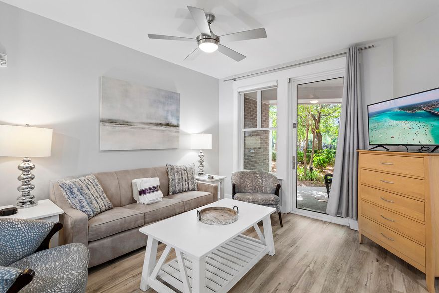 Enjoy everything the Village of Baytowne Wharf has to offer in this beautiful one-bedroom ground-floor unit in Bahia. This unit is being sold fully furnished, making it perfect for the rental market or for moving in yourself! Bahia is a bayfront building with an onsite fitness center, a lagoon-shaped pool, a hot tub, and more. The location in Sandestin Resort is filled with more to enjoy, including access to the beach, the town center-styled shopping and dining at Grand Boulevard, and the water lifestyle offered at the Sandestin Yacht Club Marina. Bahia 4109 has an open living, dining, and kitchen area with a warm, inviting look. Fashionable, comfortable furnishings include a plush tan couch and two chic patterned armchairs with sleek, stylish black ebony frames.



They ensemble around a white cottage-styled cocktail table facing a flatscreen TV on a hardwood cabinet for entertainment. Sliding glass doors lead to a covered outdoor patio with two wicker woven chairs to enjoy drinks while gazing upon a lovely garden area. A charming country table near the open kitchen has four spindle rail-backed chairs for charmed dining or a fun family game night. Two stools sit at the gleaming black mottled granite-topped bar for additional wining and dining space. Handsome black appliances accented by golden hardwood cabinetry provide everything needed to prepare a wonderful meal.

The primary bedroom has a wide window overlooking the garden patio with a comfortable king-size bed facing a flatscreen TV on a dresser for evening entertainment. This bedroom has access to a uniquely styled modern hall bath with a tub-shower combination that also serves as a powder room.

