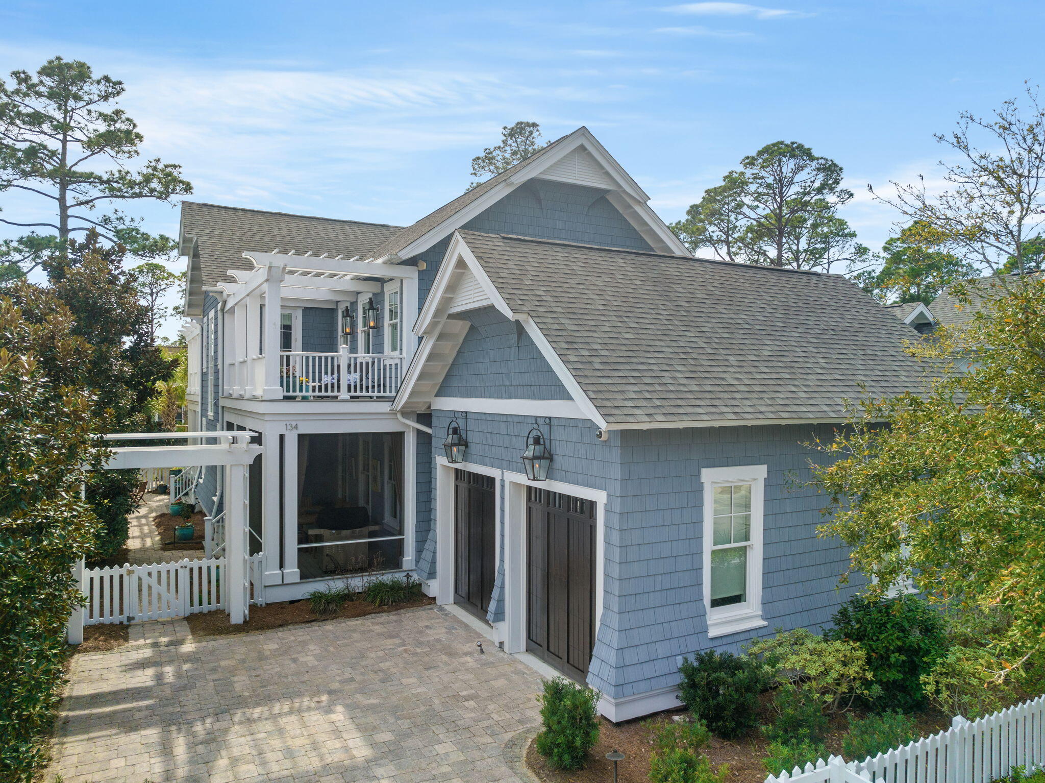 Custom built by Babin Builders in 2013 and winner of the coveted APEX award in 2014, this Watersound West Beach home, overlooking the community lake, offers the perfect blend of luxury, comfort, and natural beauty. From its impeccable design to its serene surroundings, this home is sure to captivate your heart. Designed with meticulous attention to detail, this residence boasts a timeless and elegant architectural style that seamlessly blends with the natural landscape.  With over 3,500 square feet of living space, this home offers ample room for your family and guests.   The chef's kitchen is a culinary masterpiece, featuring Wolf/Sub-Zero appliances, stone countertops, and a large center island. The combined dining and living room offers a spacious open floor plan, complete with a