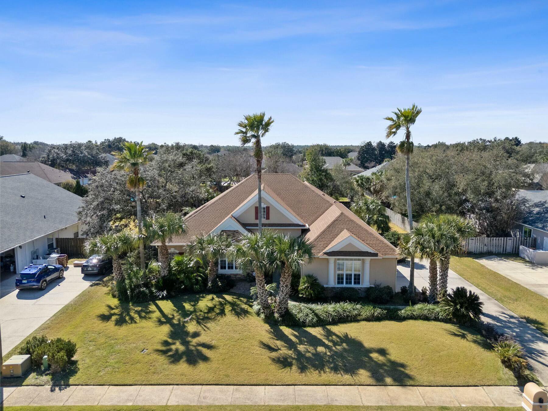Positioned in the heart of Grand Pointe, this meticulously maintained home offers a rare combination of space, modern updates and prime location. Just 10 minutes from the beach, five miles from the Shoreline Park Boat Ramp, and a short drive to Tiger Point Golf Club, it provides effortless access to outdoor recreation while offering the comforts of a well-appointed home. Designed for both relaxation and functionality, the interior features two spacious living areas, an updated kitchen with new quartz countertops and appliances, and a bonus flex room that can serve as an office or fifth bedroom. The hardwood floors complement the thoughtful details throughout, including bullnose corners and upgraded fixtures. A brand-new water heater, upgraded electrical panel, and recent master and guest bath renovations enhance both style and efficiency.
The exterior is just as impressive, with a fenced backyard offering privacy, a pool with a newer heater (2021), and a three-car garage for ample storage. Solar panels, fully paid off, provide an energy-efficient touch. Other notable updates include a new roof in 2018, outdoor gutters and new HVAC in 2020. A community park around the corner adds to the family-friendly appeal, while the nearby Naval Live Oaks Nature Preserve offers miles of scenic hiking trails and picnic spots with breathtaking views of Pensacola Bay.
This Grand Pointe home is a standout choice for those seeking both convenience and comfort in a prime Gulf Breeze location.