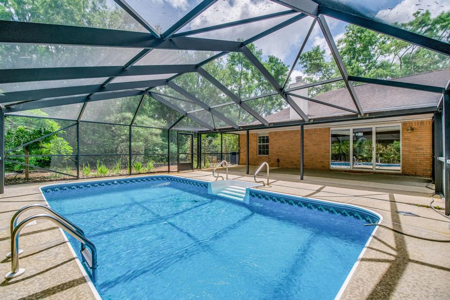 Robledal Estates is a highly desirable neighborhood in West Navarre. The neighborhood is known for its curvy roads, dog walkers, East Bay private access and lots of mature oak trees. Albino squirrels are often seen here in this yard on Calle de Ciervo. This is a one owner home that has been maintained year after year as you'll notice in person. The home features three bedrooms, formal dining room, breakfast nook that has views of the pool. The corner of the living room also features a fireplace. The septic system was replaced in 2017, the HVAC was cleaned last year, and the roof has been recently inspected and was replaced in 2011. The corner lot features plenty of oak trees and lots of shade over the home. Put your own touch on this lovely home. (click MORE) (continued) ....Change the paint color palette as you wish and it will feel brand new again! 
The home has been vacated & professionally cleaned so it's move-in ready!
No HOA, but there is a voluntary option if you wish. 
The bay side access is a one time fee to join CRABS.  Many owners join there for community events and East Bay access if you have a boat /jet skis to launch. 

This is the most affordable pool home on the market in such a desirable neighborhood!!