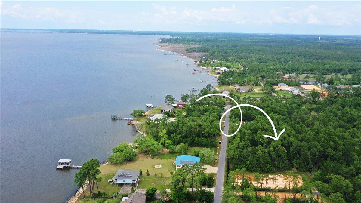 Welcome to 956 Dolphin Road located in Milton, FL. This is a vacant Lot that is 101'x212' and is centrally located to I-10 the Gulf of Mexico and the beaches of Santa Rosa County. This property is part of Escambia Bay Estates and offers deeded Key holder access just down the street to a small beach for kayaking and fishing. The Lot is level on a paved road and a future home would need to be built on pilings per the County. Built up there are potential water views of Escambia Bay for incredible sunsets. There are also 2 boat ramps within 10 mins of the property so a day on the water is very convenient.