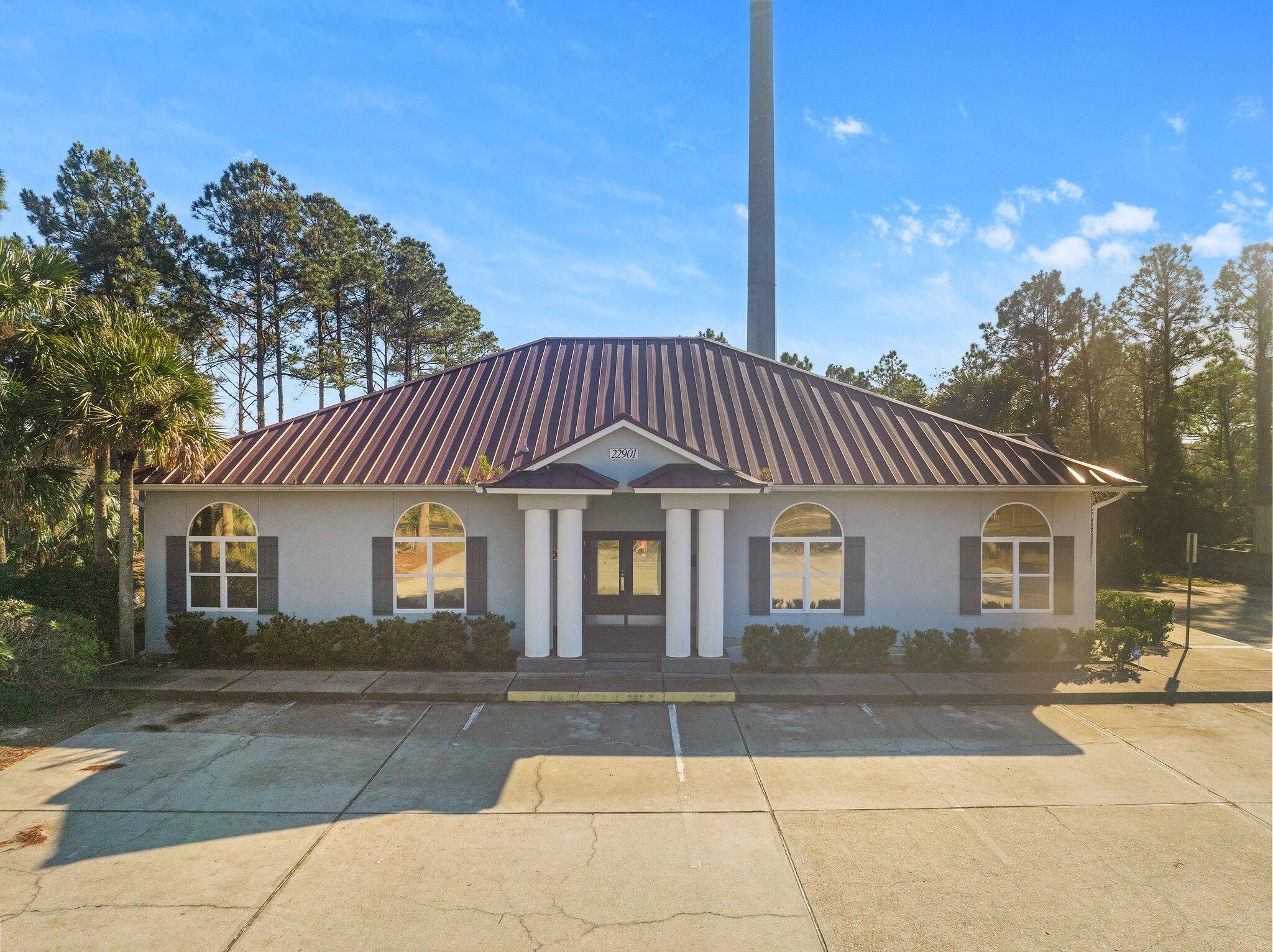 This newly renovated office offers excellent accessibility for Bay and Walton County clients and/or patients. The property is perfect for a professional office, i.e. dentist, real estate, accounting, architect. You can see Carillon Beach (right on the Walton County line) from the parking lot which makes it so close to Inlet Beach and 30a (an emerging market for a blend of 30a customers and Bay County customers). The property recently underwent a comprehensive $300,000 interior and exterior renovation, creating a fresh coastal aesthetic with every surface updated. The office features a spacious and welcoming reception and waiting area, six exam rooms, three private offices, a large kitchen and break room, a triage station, multiple common-area desk spaces, an additional break room with storage, and two half baths along with one full bath. The versatile design allows the exam rooms to be easily converted into additional private offices, accommodating various professional applications. The property spans 0.75 acres and is enhanced by a small dune lake at its southeast corner. A cell tower located on the south side of the lot, appraised at $140,000, provides nearly $700 in monthly lease income.  Floor plans under documents section of the MLS.