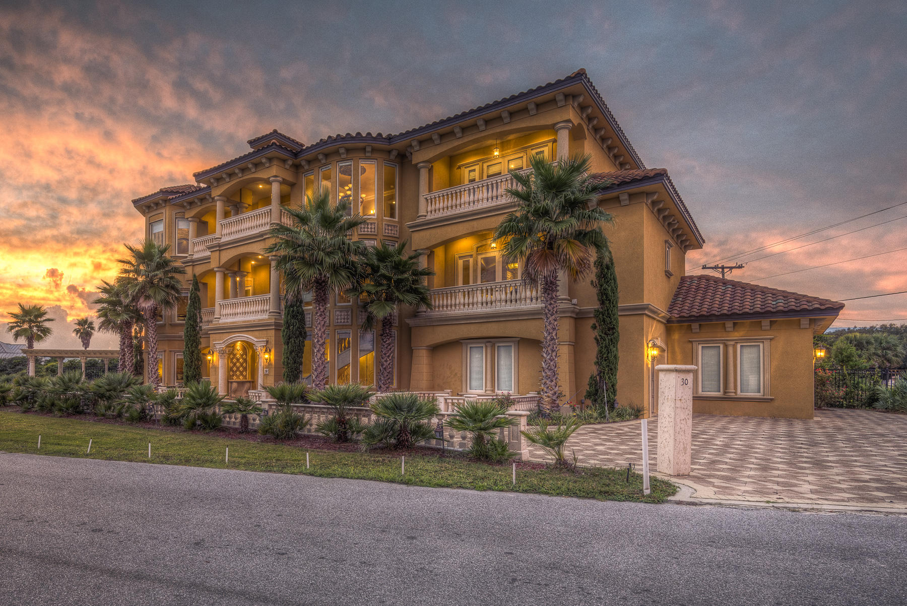 Amazing construction and design like no other along 30A. This versatile showplace could be an amazing primary or secondary home, or an EXTREMELY lucrative luxury vacation rental. The possibilities are endless. Step from the sugar white sand into elegance at this majestic residence just off of Scenic Highway 30A. The construction time span was over three years to complete this impressive grand villa that showcases immaculate craftsmanship in every detail. This well-planned design boasts over 5,000 square feet of extravagance with Gulf views galore. The spacious plan features three stories as each floor acts as its own living space with morning kitchens, bedroom suites, and additional living spaces. The first floor features a grand entryway through custom-made iron doors, a soundproof, theatre-style media room with wet bar, two spacious suites, and a Mediterranean salt-water, heated pool and spa with outdoor kitchen.For the young at heart, the pool even has a built-in cave and stone slideThe luxury finishes are apparent upon the first glance. Travertine floors with custom marble inlays throughout most living spaces, marble stairs, and custom stone balustrades carried through the exterior and interior lend itself to a true Mediterranean piece of art. The handcrafted millwork was specifically designed for each and every space. Extra large baseboards, embossed transoms above all of the 8' wooden doors, and extensive crown molding are indicative of the level of construction here. The main floor features Gulf views, extensive balconies, a stone fireplace, two custom suites, and open spaces for entertaining. The chef's kitchen boasts all Viking appliances to include a warming drawer, 4 gas burner stove with double gas grill and pot filler, dishwasher, trash compactor, wine cooler, two ovens, and a side-by-side 74" freezer and refrigerator. The elaborate double-beveled granite countertops, antique finished soft close cabinetry, and ornate Middle Eastern imported medallion embedded in the backsplash, promote the sophisticated feel of the design. Enjoy the marble stairs or utilize the elegant elevator to rise to the third floor. Upon the landing of the third floor, one will find a fitness studio of true delight featuring cork floors, floor to ceiling glass doors overlooking the Gulf of Mexico, and a morning kitchen with microwave, dishwasher, refrigerator and freezer. The two spacious master suites were thoughtfully planned with expansive balconies, designer paint colors, ornate crown molding, and faux stenciling. Each of these suites features a master bathroom with heated floors, lighted counter tops, and Jacuzzi tubs. The east wing master suite features custom cut onyx imported from China throughout the shower, tub area and countertops. The west wing master suite is a true masterpiece presenting elevated ceilings, faux stenciling, an elaborate stone fireplace, and a dressing closet with built in island and lighted makeup table. This master bathroom overlooks the Gulf and includes a two person jetted tub, walk in shower, and an abundance of ornate cabinetry and millwork. Finally, for the car enthusiast, the three-car garage will certainly do more than suffice as it is finished out with stone baseboards and epoxy-sealed flooring. Inquire today for your own private viewing.