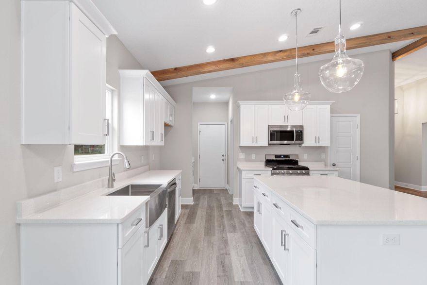 Welcome to your dream home! This semi-custom craftsman inspired brand new home offers 1,607 square feet of spacious living with 3 bedrooms, 2 bathrooms with standout features such as custom cypress wood beams and  vaulted ceiling that add warmth and character to the already beautiful design. Beautiful Kitchen with an oversized island features soft close cabinets and drawers with designer quartz countertops that is adjoined by butler's pantry. Spacious Family Room opens to white kitchen with an oversized island. Gas range, tankless gas hot water heater, and covered back patio make for a modern and comfortable living experience that you'll enjoy every day. The master bathroom boasts a luxurious free-standing tub and beautifully tiled up to the ceiling shower, offering a spa-like experience at home. You'll never have to worry about running out of hot water with the tankless water heater - a feature that is sure to impress. This incredible home is brought to you by family-owned business that builds homes with heart. When you purchase this home, you'll not only be investing in a beautiful property but in a company that values integrity, craftsmanship, and customer satisfaction. We take pride in every home we build and ensures that each one is a reflection of our commitment to quality and excellence. Don't miss out on this opportunity to own a beautiful, semi-custom home built by a company with a heart. Seller offers concessions towards closing costs. *Estimated completion Middle of October 2024* THESE ARE STOCK PHOTOS- NOT ACTUAL LOT SPECIFIC FINISHES. PHOTOS ARE OF SIMILAR PROPERTIES THAT WERE BUILT.