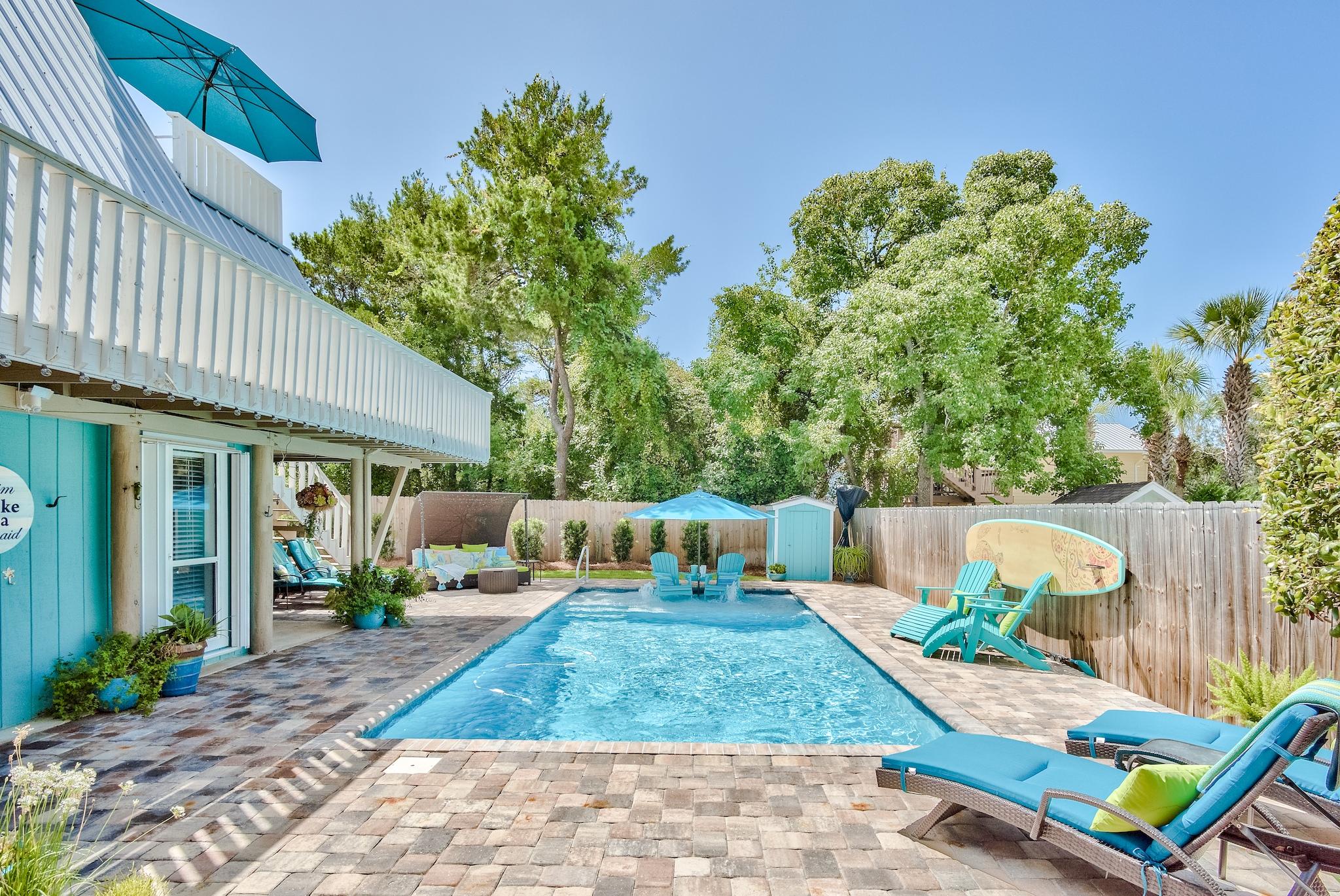 The Mermaid's Retreat is a vintage 30A cottage with style, outdoor sanctuary & unbeatable South of 30A location. This spectacular, updated A-frame invokes Old Florida charm while offering modern stylings & poolside luxury. The heated, saline 15 by 30 ft. gunite pool with sun deck & fountains & beautiful spacious backyard are difficult to find at this attractive price-point. The quiet dead-end street leads to Gulfview Heights Rd & public beach access. Gulf Place restaurants & dining are moments away. The home lives large with 3 levels & outside deck for grilling, plus covered outdoor storage area for beach goods & enclosed shower. The Mermaid's Retreat is swank sophistication South of 30A--a beach dream from yesteryear--the perfect second home/investment property. Opportunity knocks but once.