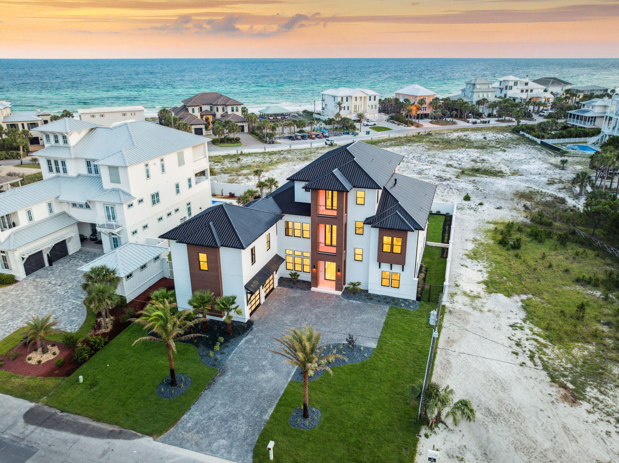 Luxury Modern Estate with Expansive Gulf Views. Welcome to a one-of-a-kind Boswell built luxury retreat where modern finesse meets coastal serenity. Nestled along the pristine shores of the Gulf of America, this architectural masterpiece offers breathtaking, nearly unobstructed views of the Gulf from nearly every vantage point. The area behind the home cannot be built on ensuring Gulf views for the future of this home.Boasting high-end finishes throughout, the home is thoughtfully designed with both style and functionality in mind. An in-home elevator connects all levels of this smart-home-enabled residence, allowing for ultimate convenience and control. The main living area opens to a chef's dream kitchen outfitted with state-of-the-art Thermador appliances, sleek cabinetry, and a hidden butler's pantry for seamless entertaining
A temperature-controlled wine room and a fully equipped theater room elevate the lifestyle experience, offering refined spaces for relaxation and leisure. The home also features a guest suite complete with a full kitchen and living space.
Designed for entertaining, the expansive recreation room leads directly to the outdoor oasis, featuring a large perimeter overflow pool, spacious sun deck, and lush modern landscaping as well as a fully equipped outdoor kitchen. Oversized outdoor balconies provide the perfect setting to enjoy sunsets over the Gulf. This home also features a whole house generator.
The master suite, located on the third floor, is a sanctuary of luxury, complete with large sliding doors for awe-inspiring Gulf views, a spa-like en-suite bath, and a custom walk-in his and her closet.
Elevated touches like large-format main tiles, warm cypress wood accents, and designer lighting enhance the home's modern aesthetic, while every detail, from the spacious layout to the thoughtful finishes, reflects unparalleled craftsmanship.
This estate is not just a home; it's a lifestyle. Schedule your private tour today and experience the pinnacle of modern luxury.