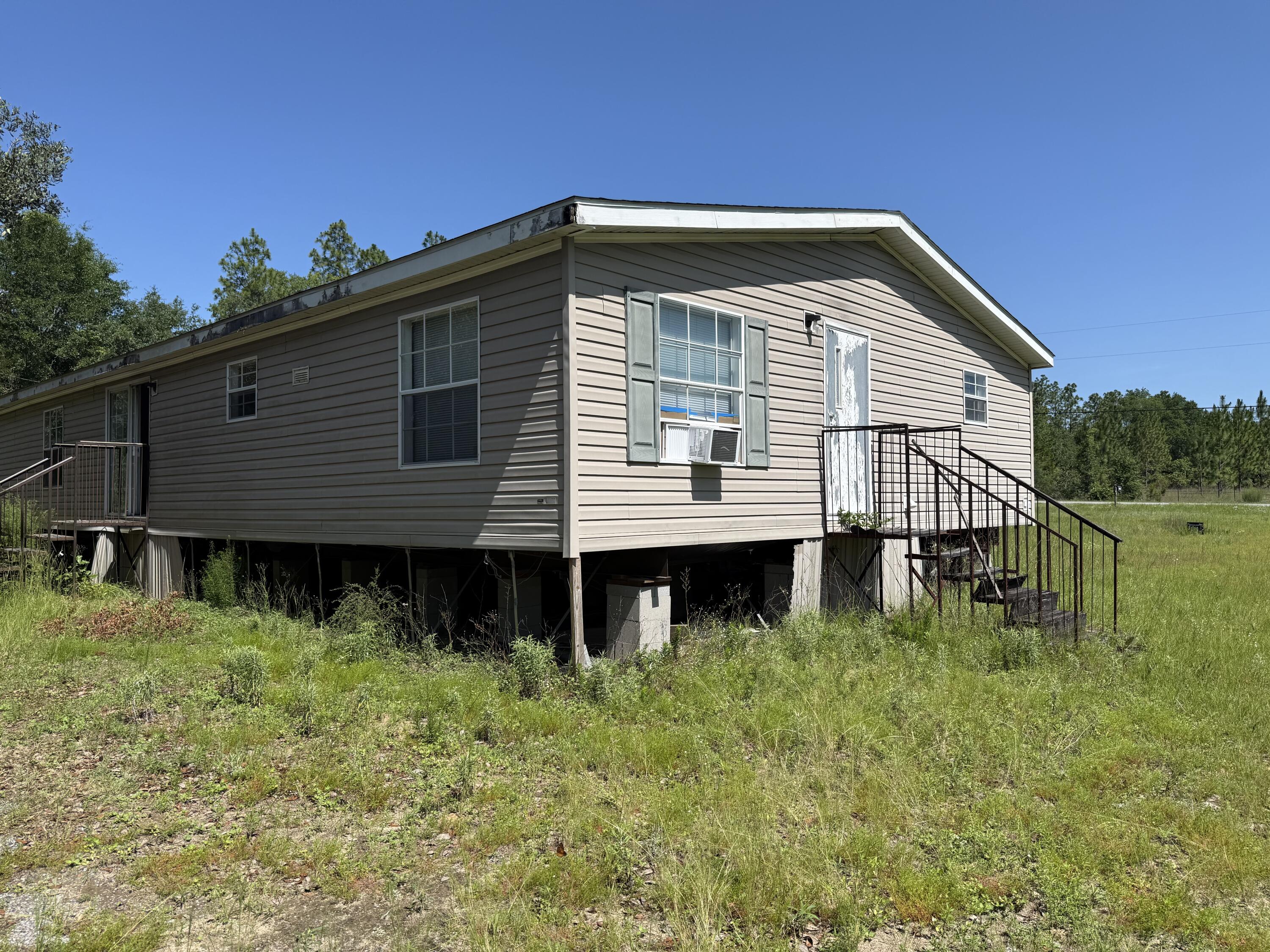 Spacious 5 Bedroom, 3 bathroom mobile home being Sold AS-IS. Situated on a 1.01 acre lot, this property offers a great opportunity for renovation or a potential homesite for new construction. Conveniently located with easy access to local shopping , military bases, and beautiful beaches.