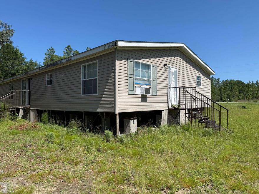 Spacious 5 Bedroom, 3 bathroom mobile home being Sold AS-IS. Situated on a 1.01 acre lot, this property offers a great opportunity for renovation or a potential homesite for new construction. Conveniently located with easy access to local shopping , military bases, and beautiful beaches.