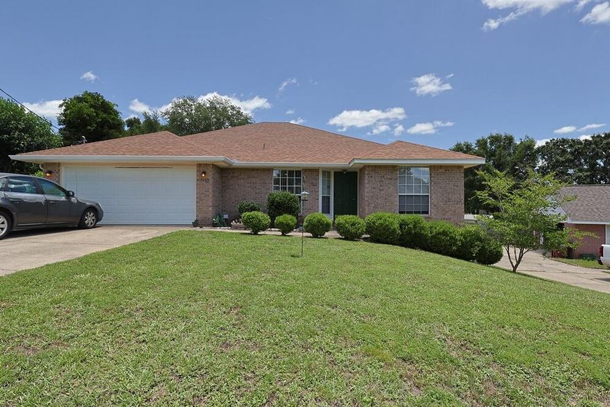 This charming brick home offers 4 bedrooms and 2 bathrooms with a spacious open split floor plan. The living room features vaulted ceilings and chair railing, creating an open and inviting atmosphere. The kitchen includes a breakfast bar, tiled backsplash, and wood laminate flooring, with durable flooring continuing throughout the main living areas.Additional features include an attached 2-car garage, an indoor laundry room, and a large open deck overlooking a fully fenced backyard, providing ample outdoor space. The property is located in Antioch Estates in Crestview, south of Interstate 10 and approximately one mile to I-10 access. Conveniently located near Eglin Air Force Base and within the Okaloosa County School District.