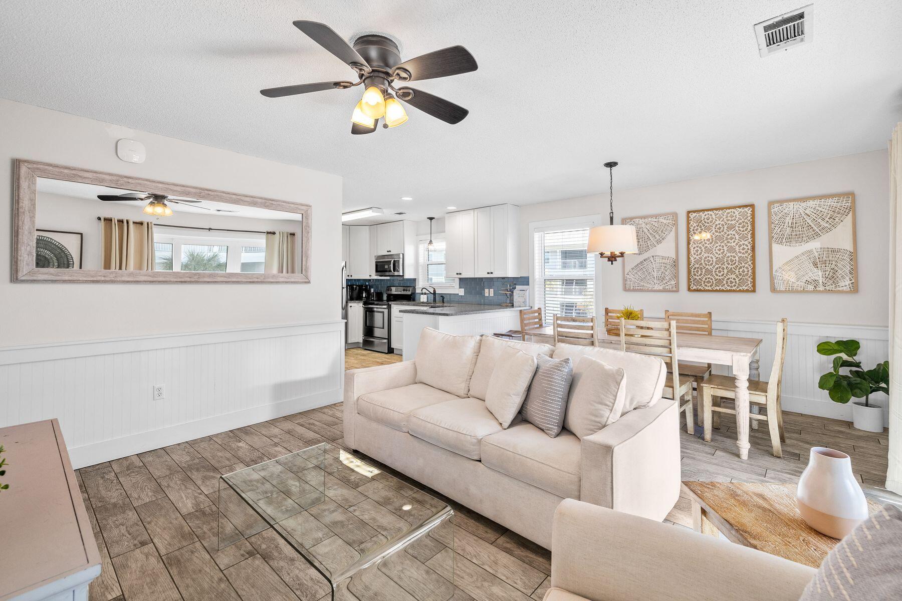 This three-bed, two-bath beach retreat is superbly located just three back from the white sandy beach. Attractively priced, it is fully updated with great potential as a vacation home or rental investment. Practical wood-look tile flooring and granite countertops give the entire condo a fresh, upscale vibe, along with well-appointed furnishings and neutral decor. Leave your car in your designated parking spot (one of two) right outside the door and head to the second floor. The open living room is spacious and bright, with multiple windows. The L-shaped floor plan includes a dedicated dining area for mealtimes after a full day's activities. There's a breakfast bar for additional seating. The kitchen comes fully equipped with stainless steel appliances and white Shaker-style cabinets. Granite countertops and a shiny glass backsplash complete the appeal. A Brand New washer and dryer are housed in a separate utility room, keeping everything neat and tidy. The generous sitting area invites you to relax on the comfy sofa and put your feet up in front of the TV. Enjoy refreshing breezes through sliding glass doors that open onto a balcony. It offers a private space where you can enjoy the views from an elevated vantage point. The balcony can also be accessed directly from the master bedroom with its ensuite bathroom and walk-in closet. There's a second bedroom with a queen bed, plus a bunk room with twin over full bunk beds. There's ample space for a trundle bed, too. A second full bathroom completes this spacious vacation retreat. Tennis courts, shuffleboard and a beautiful communal pool, keep everyone entertained when you're not swimming, walking and relaxing on the stunning sandy beach. Located midway between Seaside, Florida, and The Hub, this Beachside Villa retreat offers endless options for dining, shopping and entertainment, making every day feel like a true vacation.