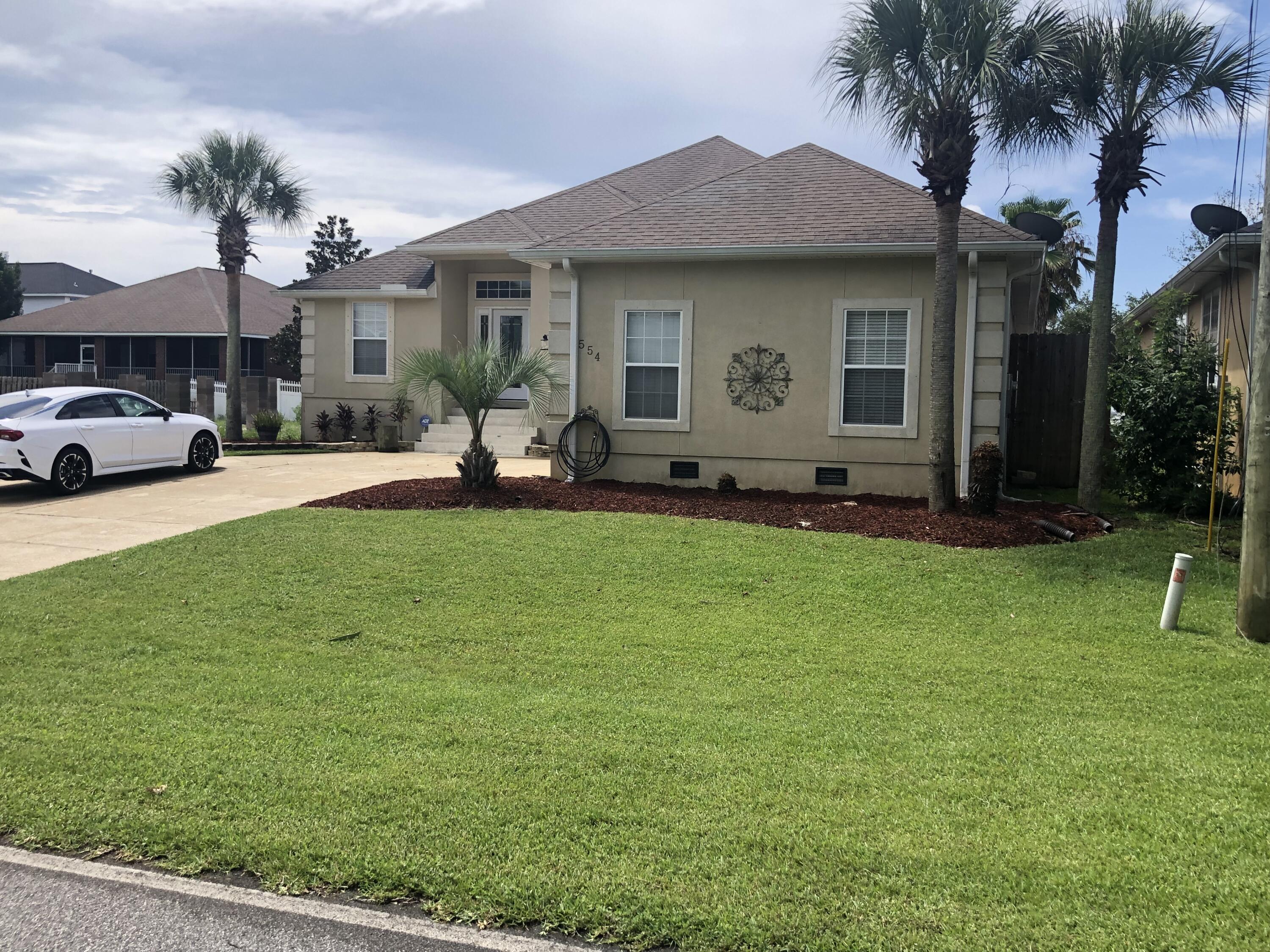 RARE FIND! This custome built 4 bedroom home with private inground pool is located minutes from Hurlburt Field. This pristine home is in a private community located on the intracoastal waterway. The community includes a gated, large new dock, beach, fishing, gazebo, etc. The open floor plan features 10 ft ceilings, split bedroom plan, large sunroom which overlooks the pool and deck. A huge master bedroom has room for a sitting area and private door to the pool area. Professional potos are being taken July 6th.