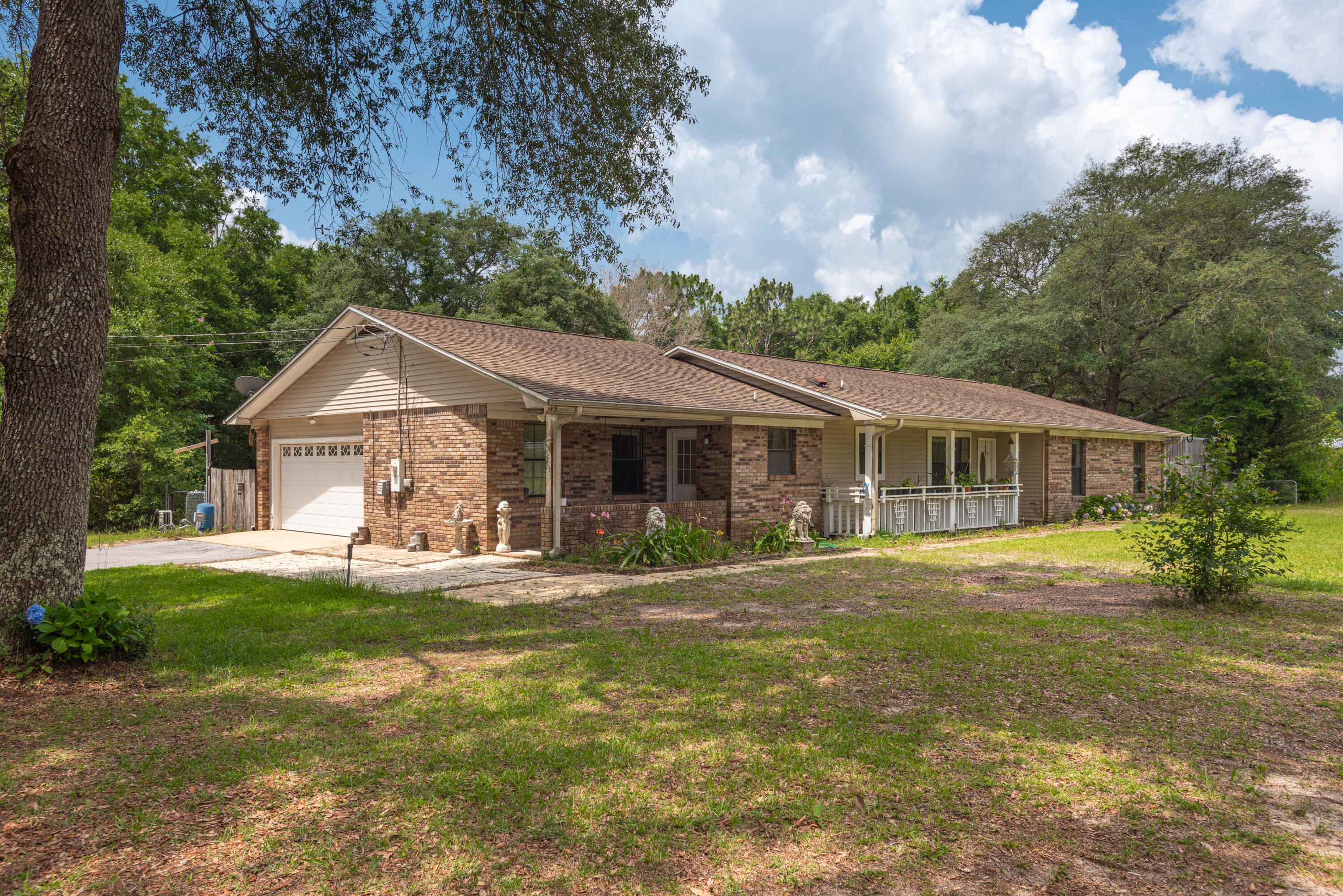 This homes sits on a beautiful private 2 acre  corner lot close to I10, downtown Milton, Blackwater River and Gulf of Mexico.  3 bedrooms and 2 full baths, updated eat in kitchen, living room with fireplace, heated and cooled Florida room, formal dining room, mud room and laundry room.  Outside is a covered pavilion 17 X 12 , green house and 21 X 21 2-car carport. Being sold AS-IS and ready for you to make it your own.
