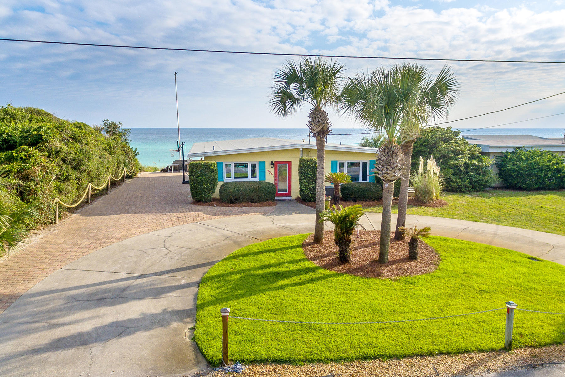 Under contract with a 72 hour kick-out clause. For those who crave the simplicity in beachfront living, just steps from the Gulf of Mexico, this Blue Mountain Beach property is for you. Poised on top of a sand dune at one of the highest coastal elevations in Florida with 75-feet of water frontage, this classic single-floor concrete block cottage, built in the 1960s, embraces its era with original terrazzo floors, exposed wood timbers and vaulted ceiling. The bright open kitchen boasts modern white appliances, and updated electrical wiring allows modern lighting to gracefully illuminate the home. The spacious great room with built-in shelves, flows easily to the wide Trex deck and beach, offering abundant opportunities for entertainment.