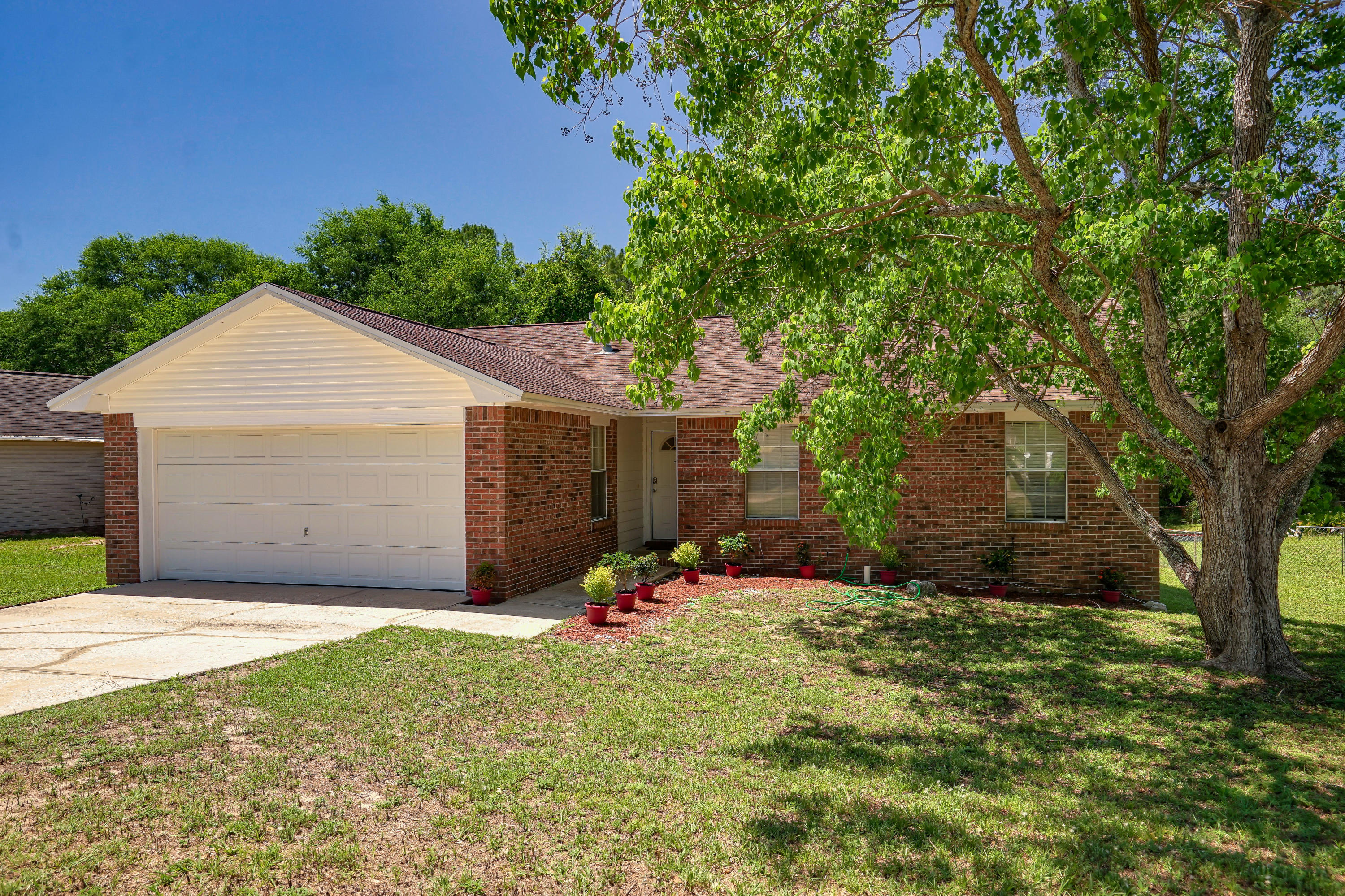 Adorable home south of I-10. This home is move in ready with a large lot. Spacious kitchen and dining area, family room features a wood burning fireplace with brick hearth, sliding glass door that leads to a deck over looking the large backyard. The two car garage has plenty of storage space. Practical information, roof is 2005 and is an architectural shingle, septic was inspected and pumped in 2017 report available, wind mitigation available as well. Convenient to 7th Special Forces Group and Duke Field. Call to see this well priced home.