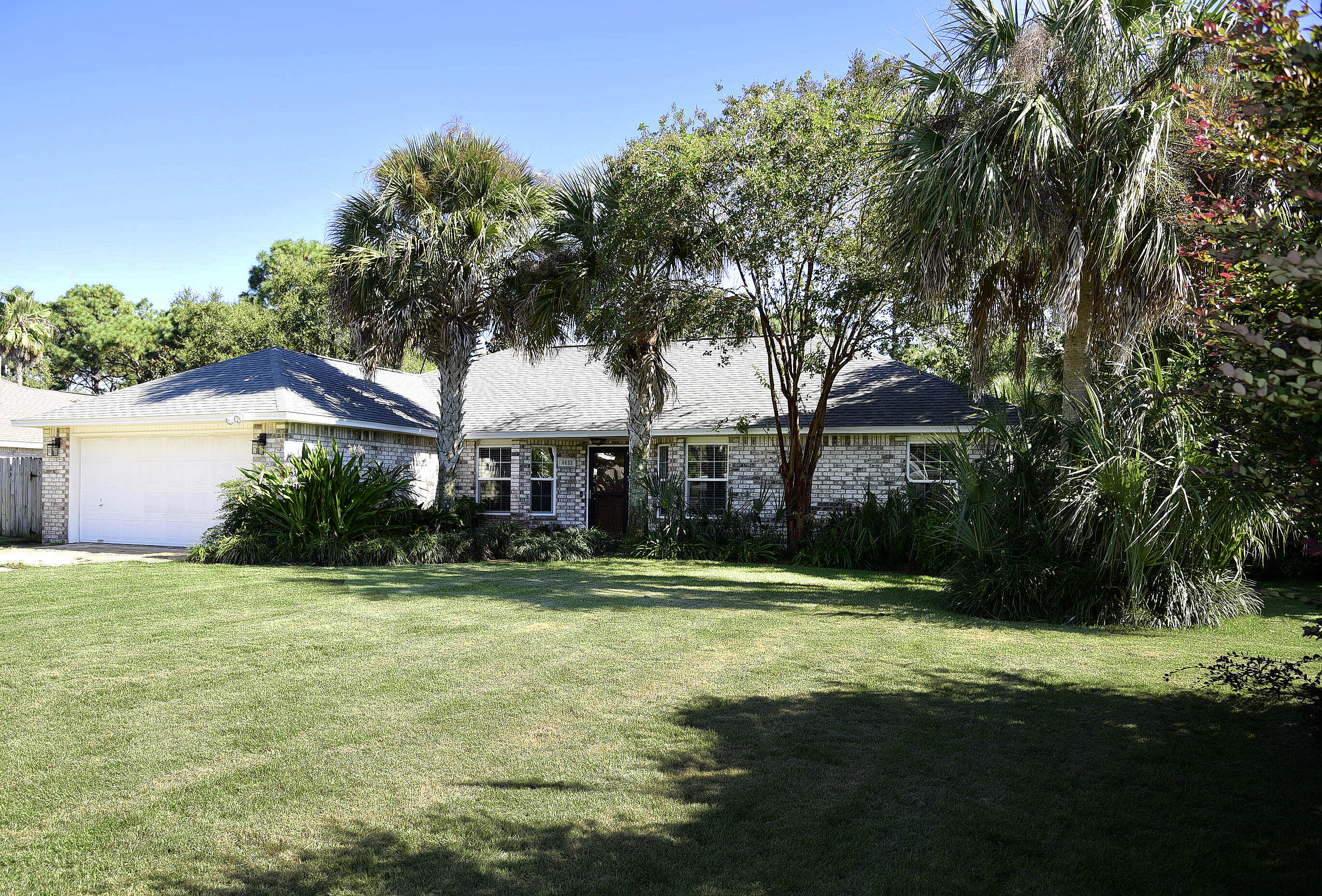 Gorgeous COMPLETELY RENOVATED all brick home with a pool in highly desired Raintree Estates! No expense spared in this beauty! High-end luxury vinyl plank flooring throughout. This chic 3 bedroom, 2 bath home with an office is everything you've been looking for and more. Upon entry, your eyes will be drawn to the cathedral shiplap ceilings and wooden beam with designer lighting. To your right, through glass pane French doors is a dedicated office with built-in cabinets, shelving and lots of natural light. From there, you'll enter the spacious open living room with a custom-tiled and trimmed gas fireplace and double glass doors with custom drapery looking into the resort style backyard.  Off the living room is a eat-in kitchen area with plenty of space for a large dining set. The luxuriant