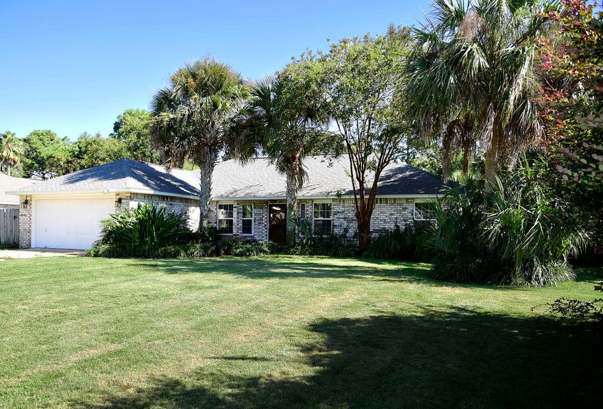 Gorgeous COMPLETELY RENOVATED all brick home with a pool in highly desired Raintree Estates! No expense spared in this beauty! High-end luxury vinyl plank flooring throughout. This chic 3 bedroom, 2 bath home with an office is everything you've been looking for and more. Upon entry, your eyes will be drawn to the cathedral shiplap ceilings and wooden beam with designer lighting. To your right, through glass pane French doors is a dedicated office with built-in cabinets, shelving and lots of natural light. From there, you'll enter the spacious open living room with a custom-tiled and trimmed gas fireplace and double glass doors with custom drapery looking into the resort style backyard.  Off the living room is a eat-in kitchen area with plenty of space for a large dining set. The luxuriant The luxuriant kitchen will 'wow' you with the custom "anchor blue" cabinetry, quartz countertops, subway backsplash, large single bowl sink with matching stainless-steel appliances, including a gas range for the culinary enthusiast. The master bedroom is off of the kitchen, keeping with the coastal design of the home with a navy-blue accent well providing depth and texture to the already substantial sized room.  The ensuite adorned with marble tile, double vanity, soaking tub, separate tiled shower and walk-in closet. On the other side of the home, you will find 2 bedrooms, each unique as well.  Custom shiplap wall with shelf in one room, inviting view of the backyard in the other room.  Between the 2 bedrooms is a well-appointed guest bath with octagon tile flooring and dark grey undermount single sink vanity with Carrara engineered marble. We've saved the best for last...the backyard...the tropical oasis awaits! Custom Gunite pool with fountain, surrounded by brick pavers, lush landscaping with scores of tropical plants and trees, sand firepit and plenty of privacy. The scenery is just as breathtaking in the evening as each grouping of palm trees is lit up with an automatic timer. 

Raintree Estates boast an optional membership HOA of only $150/year and allows access to 2 private parks; a fully secluded Woods Park with wooded walking trails, soccer field and a baseball diamond.  The Beach Park is equally as impressive with a community dock, kayak launch, pavilion, BBQ grill all with access to the Choctawhatchee Bay.  This waterfront community is conveniently located just 6.5 miles to Destin's world-class beaches, restaurants and shopping.