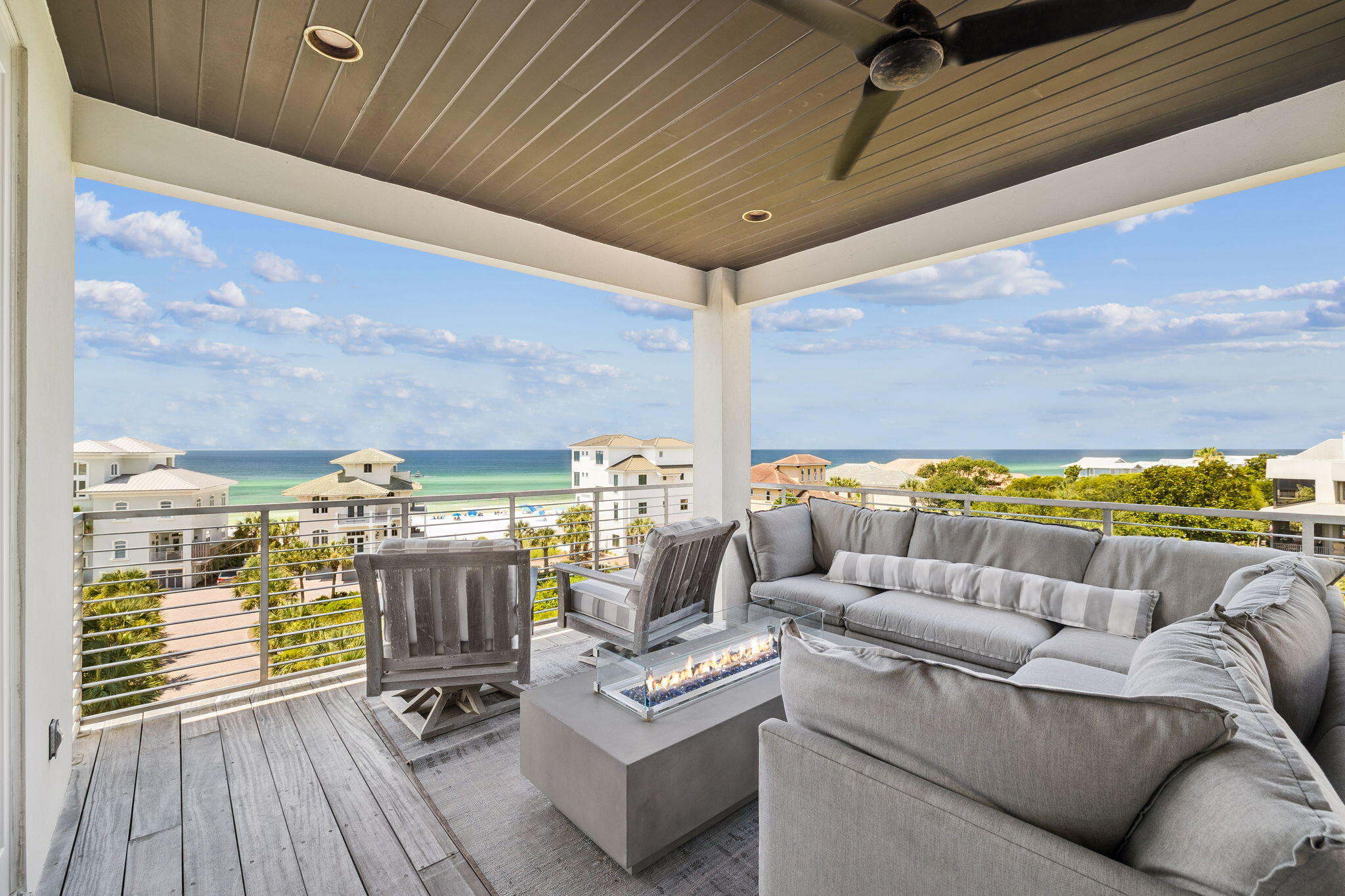 This luxurious home is located south of 30A at Caspian Estates in a corner lot with forever Gulf views. The neighborhood has nine homes with 2 private entry gates and a pool. This 4,858 sq ft home has 5 bedrooms, 5 full baths, and 3 half baths. The house has a 2-car garage and front porch sitting area both with exterior gas lanterns. House has a custom millwork staircase with gorgeous chandeliers and 4 floor accessible elevator.The first floor includes an entry foyer, staging area, humidity-controlled wine cave, oversized laundry room with washer/dryer, storage closet, half bath, bar with sink/refrigerator/ice maker, and guest bedroom with king-sized bed, full bath & double closets. The laundry room opens to an exterior walkway with access to an outdoor shower with hot & cold water. The second floor includes a guest suite with full bath, laundry closet with washer/dryer, and primary suite. The guest suite includes a "swinging" king bed & two custom wall mount bunk twin beds, bathroom with double sinks and soaking tub & shower, and walk-in closet. The double-door entry to the primary suite has a feature wall behind king-size Tempur-Pedic bed with dual controls, built-in cabinets, morning bar with refrigerator, and wall-mounted television. The master bath includes a spa bath with a freestanding tub and double head shower with Kohler audio system, double sinks, Bidet toilet, and walk-in closet with vanity table, lighted mirror & sink. The primary suite leads out to a private covered 2nd floor porch with forever Gulf views from the swinging bed.
The third floor with 11 1/4 ft ceilings includes the main living room with gas fireplace, dining room, kitchen, bar with sink/ice maker/refrigerator, half bath, and bedroom with full bathroom with double sinks. The gourmet kitchen has high-gloss white cabinets, backsplash window, corner pantry, and center island. Kitchen has Jenn Air appliances including refrigerator, gas range, double ovens, built-in microwave, built-in coffee/cappuccino maker, and dishwasher. The 3rd floor covered balcony is accessible from the living room and the kitchen with retractable sliding glass wall doors that open to a corner porch with a built-in Lynx grill & dining area with beautiful sugar sand & Gulf views.
The fourth floor includes ocean-view living room, half bath, and junior primary suite. The living room has a wet bar area with liquor storage, Sub-Zero wine tower refrigerator, & icemaker as well as television retractable from ceiling stowage. The junior suite with Gulf views includes a king-sized bed and bath with double closets, storage closet, shower, and double sinks. The 4th floor balcony is accessible from the living room as well as the junior primary suite. This balcony is 447 sq ft with forever Gulf views covered terrace with gas firepit sectional seating & television sectional seating areas.
This contemporary home has been professionally furnished and styled for the beach community south of 30A.