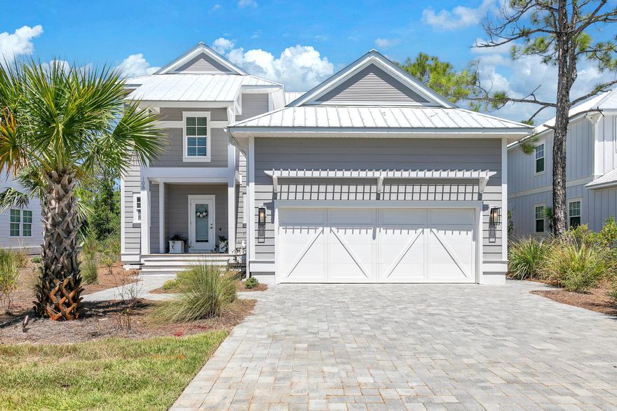 Discover this stunning, like-new home on the coveted west end of 30A, nestled in the charming Heron Crossing community. Built by the esteemed Cole Construction, this immaculate 4-bedroom, 3.5-bath residence offers high-quality finishes including hardwood floors, granite countertops, stainless steel appliances, and elegant crown molding. The main level features a spacious, open-concept living and dining area, seamlessly connecting to a chef's dream kitchen with a large island and pantry. Enjoy additional conveniences with a wet bar and beverage station. The primary suite is also located on the main floor, providing easy access and comfort. Upstairs, you'll find three more bedrooms, two full baths, and a versatile loft area complete with custom-built bunks. The home has never been rented and has been meticulously maintained.  Heron Crossing is a serene, small community with a lovely pool and is adjacent to the scenic Topsail Hill Preserve State Park. The pristine Topsail Beach, renowned for its tranquility, is within walking or biking distance. Additionally, a short drive will take you to Grande Boulevard, where you'll find upscale shopping, dining, a movie theater, Publix, and more. HOA fees include access to the community pool, and maintenance of common areas.