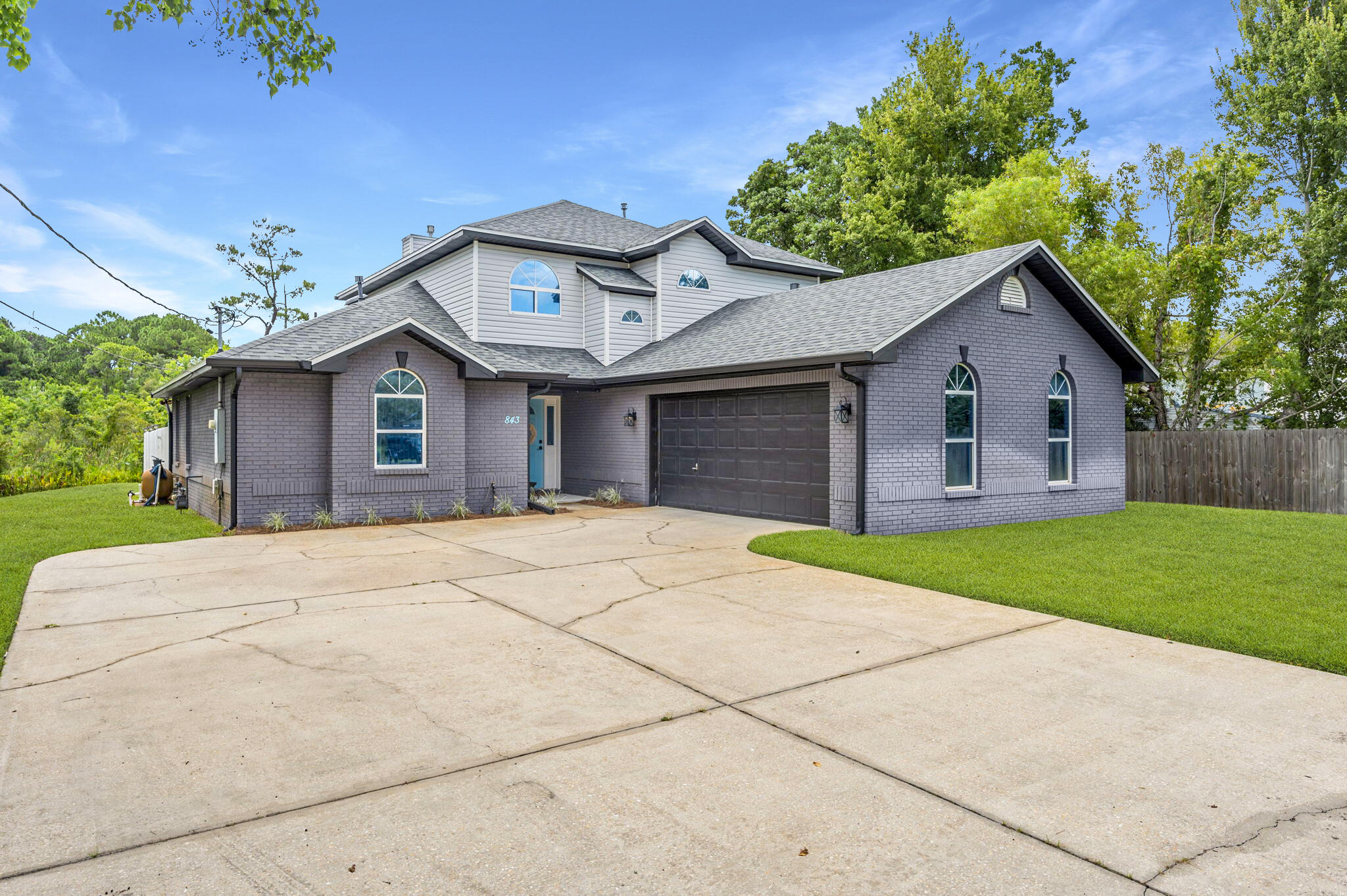 Tucked away on a private cul-de-sac without an HOA, this beautifully maintained 2,111 sq ft home offers 3 bedrooms, 3 baths, and timeless curb appeal. Step inside to soaring cathedral ceilings centered around a cozy fireplace, with natural light streaming through high windows that frame tranquil views of the protected preserve behind.Just off the living room, the fully renovated kitchen is a chef's dream, featuring quartz countertops, stainless steel appliances, an oversized pantry, and an open flow to the dining area--perfect for entertaining. From here, step into the heated and cooled sunroom or out to the expansive pool deck for seamless indoor-outdoor living. The spacious first-floor primary suite offers a true retreat, featuring a lit tray ceiling and a luxurious en-suite with dual sinks, a private water closet, jetted tub, walk-in shower, and his-and-hers closets. French doors open directly from the bedroom to the pool, creating a private escape just steps away.
Upstairs, you'll find two additional bedrooms, a full bath, and a versatile loft ideal for an office, media room, or play space. Outdoors, enjoy the serene backyard with a sparkling pool and unobstructed preserve views with no rear neighbors, just nature. A two-car garage and oversized driveway provide abundant parking and storage for vehicles, guests, or recreational gear.
With a new roof installed in 2021, and newer HVAC 2017, this home has been immaculately maintained and is truly move-in ready. Located just minutes from Hurlburt Field's front gate and the sugar-white sands of Okaloosa Island, it offers the perfect blend of privacy, convenience, and resort-style living.