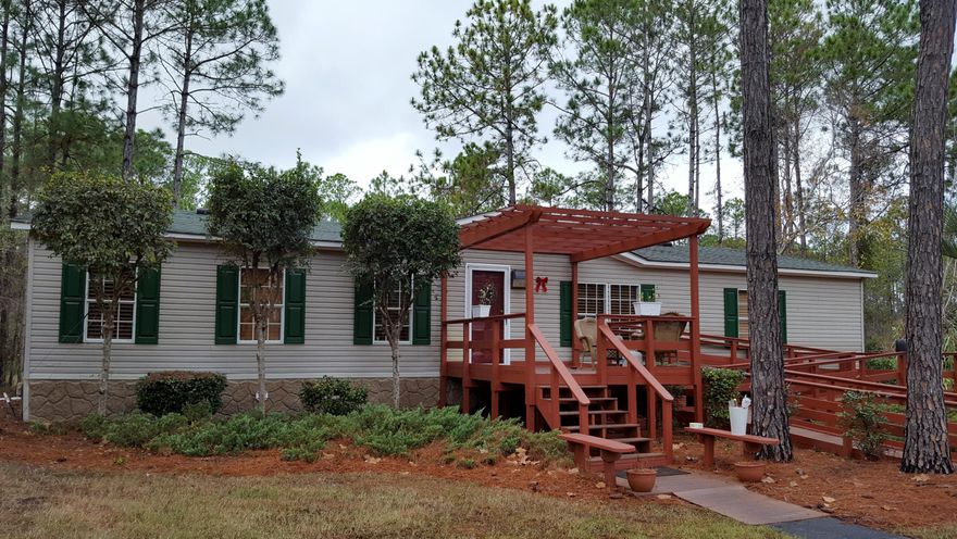 This beautiful 3 Bedroom 2 Bath Manufactured Home sits on a beautifully landscaped large lot. The nearly 800 sq. ft. of outdoor screened in living area is host to a gas fireplace, 3k gal 14x8 spa and gas grill which is a great space for entertaining. Home is only minutes from the Bay and Beaches of South Walton. The home has many upgraded features to include 2007 Shingled Roof, cabinets, counter tops, wood laminate floors, 3'' Wood custom blinds, new fixtures, electric fireplace, irrigation system, 4 Ton Package AC Unit, Security System and much more. A MUST SEE TO APPRECIATE!