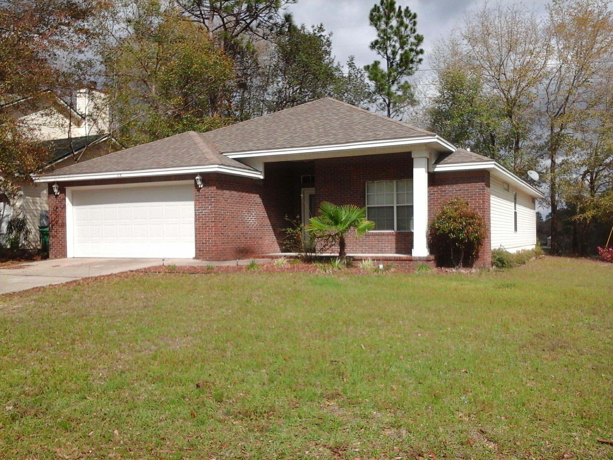 Beautiful brick front home with a lake view from the dining room, master bedroom, screened lanai and large back yard. This lovely 3 bedroom 2 bathroom home is situated on a corner lot in a desirable southeast location. The entry way opens up to the living area with high ceilings and a ceiling fan with remote. The home has ceramic tile through out with wood floors in the large master suite. The master bath offers double sinks with a makeup vanity, walk in closet plus a separate linen closet. The second and third bedroom are connected by a small hallway, just off the living area, with the second bathroom conveniently located between the two bedrooms.The front bedroom offers a large picture window for a lot of natural light. Both bedrooms have nice large closets.