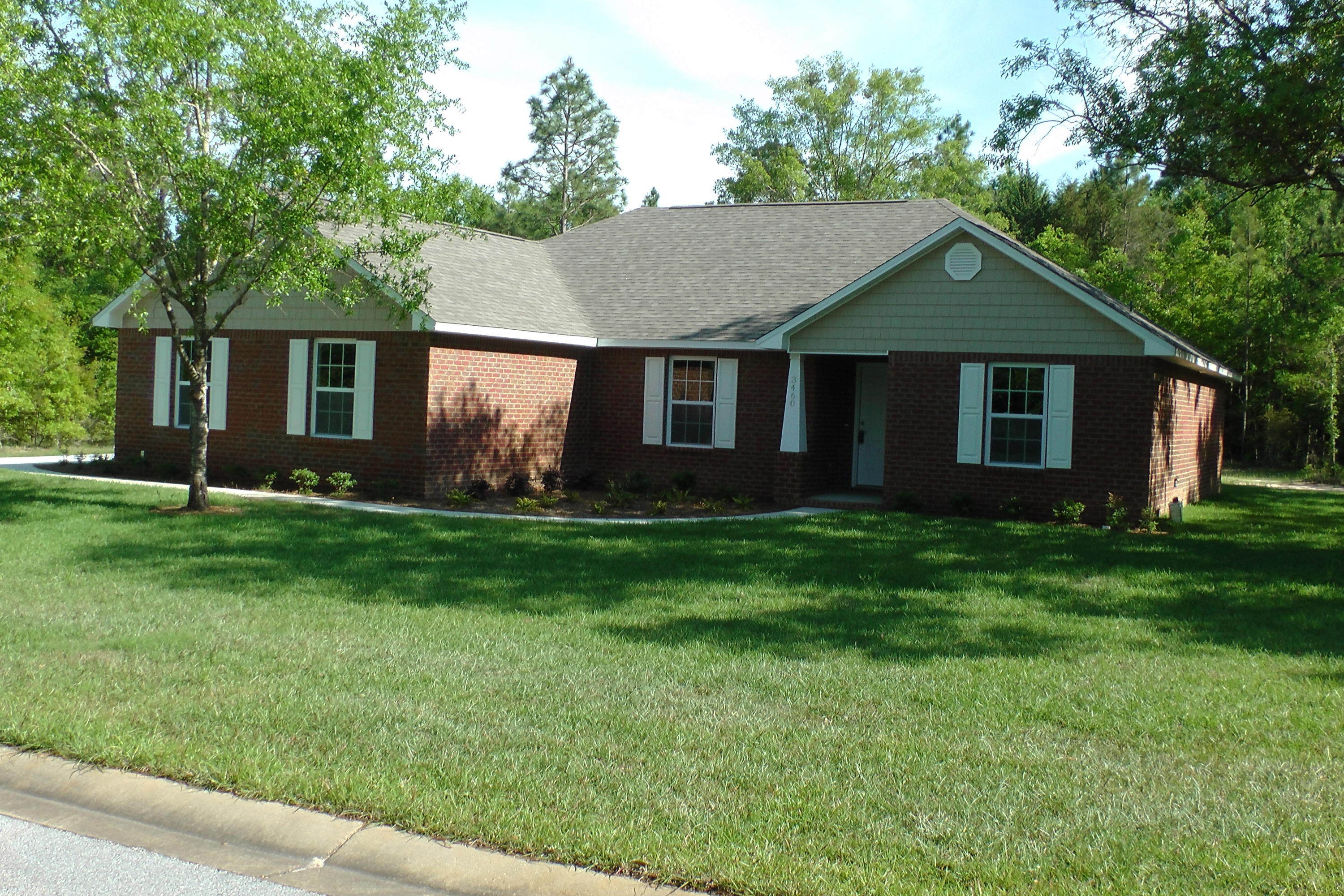 Beautiful NEW home in Ashtin Estates, a lovely, level subdivision with underground utilities and 1/2 acre, shaded lots! - Great plan - Open LR, Dining, and kitchen - Cathedral Ceiling in Living Room. Other Ceilings are 8 feet. Maple Cabinetry with raised panel doors, granite counter tops, and stainless steel appliances; tile flooring in Baths, Laundry, kitchen and Dining area, Laminate in LR,Carpet elsewhere. Outside is all Brick. Master Bath awesome! Large Garden tub, marble vanity tops, large walk-in closet. Covered Patio. This lot is level, 1/2 acre has beautiful hardwood trees.