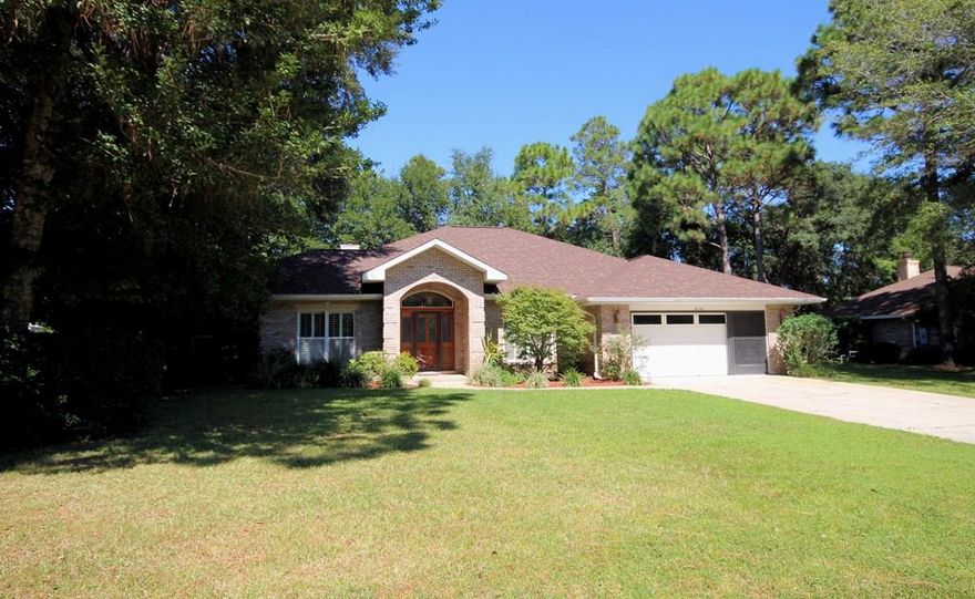 Rocky Bayou Estates all brick home with a NEW roof on a -1/2 acre, tree shaded, fully fenced lot. This 2750sf home lives LARGE and features an open floorplan with separate living areas. When you enter this home through the wide tiled foyer you will immediately notice the warm hardwood flooring and raised ceilings. The formal dining room on the right flows into the living room accented by a gas fireplace and built in entertainment center. The living room also opens to a private home office and it has triple sliding glass doors leading to the bright, tiled Florida roomthe ideal space for almost any use. The updated kitchen offers plenty of cabinet and counter space, tiled floors and stainless appliances. This is a split floorplan with the master suite on one side of the house and 2 addition