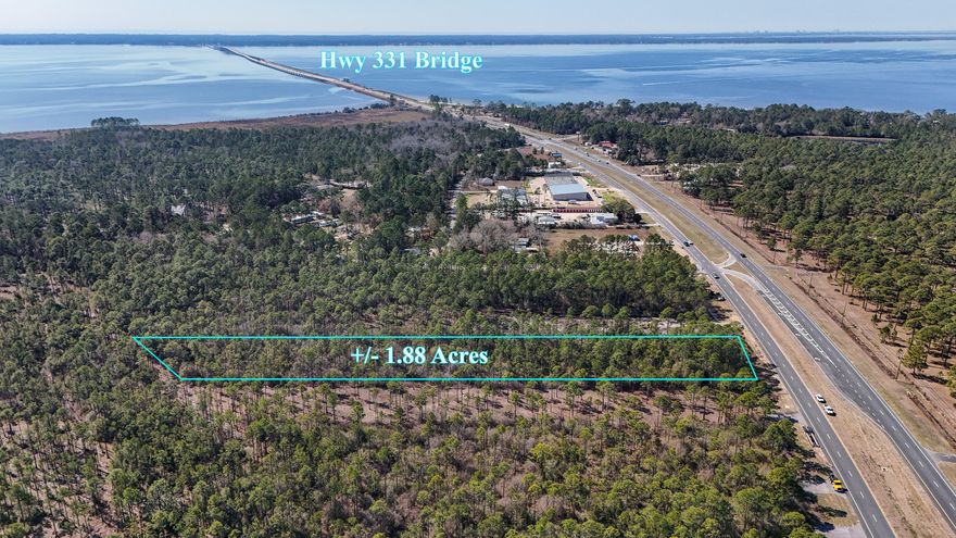 Prime +/- 1.87 ac parcel with 100' of frontage on the east side of Hwy 331S.  This property is between County Hwy 3280 and Choctawhatchee Bay.  Don't miss the chance to invest NOW in the center of pending growth!  Tremendous commercial potential. Currently zoned Rural Village/Mixed Use.  Survey available under Documents.  Buyer to verify all information.