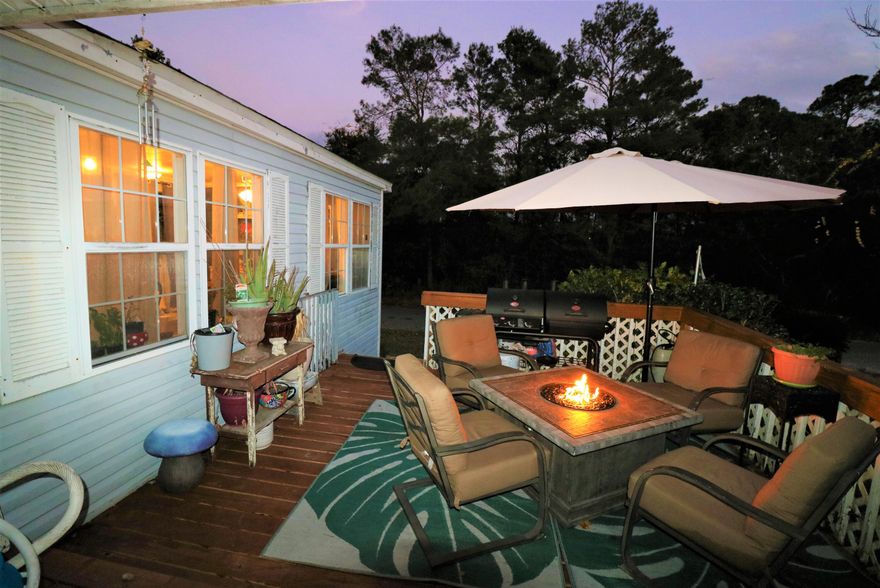 Highest and best offers due by 5pm Jan 1. This beautiful waterview L-shaped home will make a great vacation rental or main residence with all the space and PRIME location. It's on the south/water side of 98/Navarre Pkwy, a few feet away from the sparkling waters of the Santa Rosa Sound, and only a mile or so to be enjoying the sugar sand beaches of Navarre Beach.  WOW....as of 12/5/2022 it is the lowest price of the currently listed homes that are closest to the large waterways! At closing, The inviting front deck was just redone and ready for your get-togethers. Inside you will be delighted to find 2 spacious living areas (both with french door entry's) and a welcoming kitchen/dining area with eat-in bar...all awaiting your large gatherings. BONUS: Washer and dryer are included, new roof 2017, water heater 2021, keypad entry on doors, and fenced back yard. There is a pretty vacant lot behind the home and across the street is lushly wooded. The master suite has a full bath, separate vanities, and a luxurious 2 person soaker tub. You will be delighted to use your chef skills in the fully appliance stocked kitchen to include a french door refrigerator with water and ice dispenser on door, flat top range, AND a wall oven/microwave combo. The home has newly replaced window units in every room. There is an inside Trane central heat unit installed. Home has pretty much been recently all re-plumbed, septic tank pumped in 2021, and has been updated to Florida code with all additional hurricane straps installed. Located on a dead-end street (Santa Rosa Sound is at end) with no cross streets, very near to boat launch, schools, major grocery stores, medical facilities, world-renowned restaurants, Hurlburt Field, and about a mile or so to the longest fishing pier in the Gulf of Mexico! Double-wide had a permitted addition of the 2nd living room and 4th bedroom in 2004. Motivated Seller's 