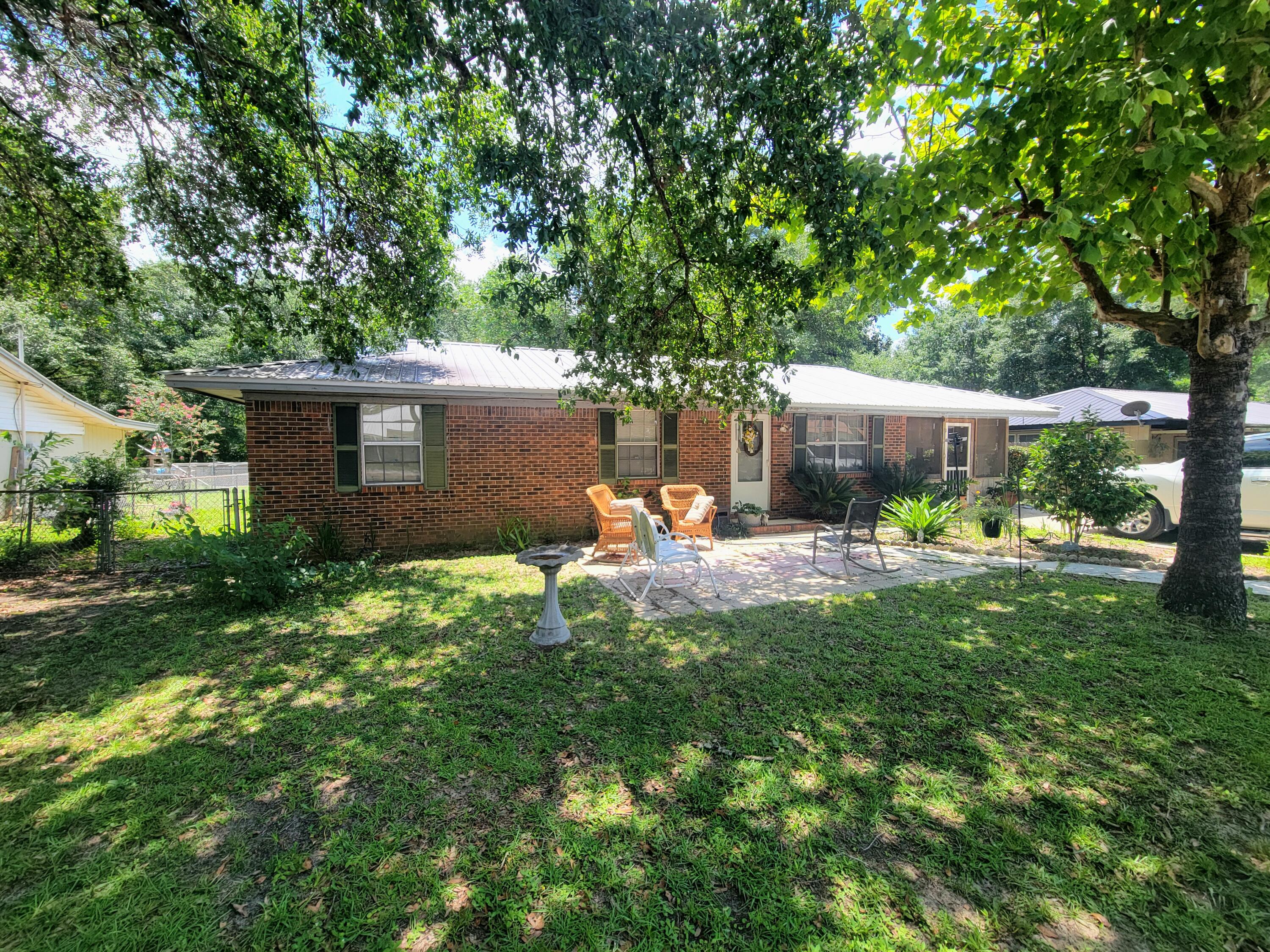 It just feels like home! This well built brick home has a metal roof (2013) and a yard that feels like 'family get-togethers' front and back. Kitchen has lots of cabinets and the dining area is large enough for full size table and accessories. Three bedrooms and 1 bath. The carport is screened in to enjoy the mornings and late evening family and friends. The back yard is fully fenced and has a sweet garden spot to grow your own vegetables plus a must-have utility building. Property is in the city limits just off Hwy 331 N.