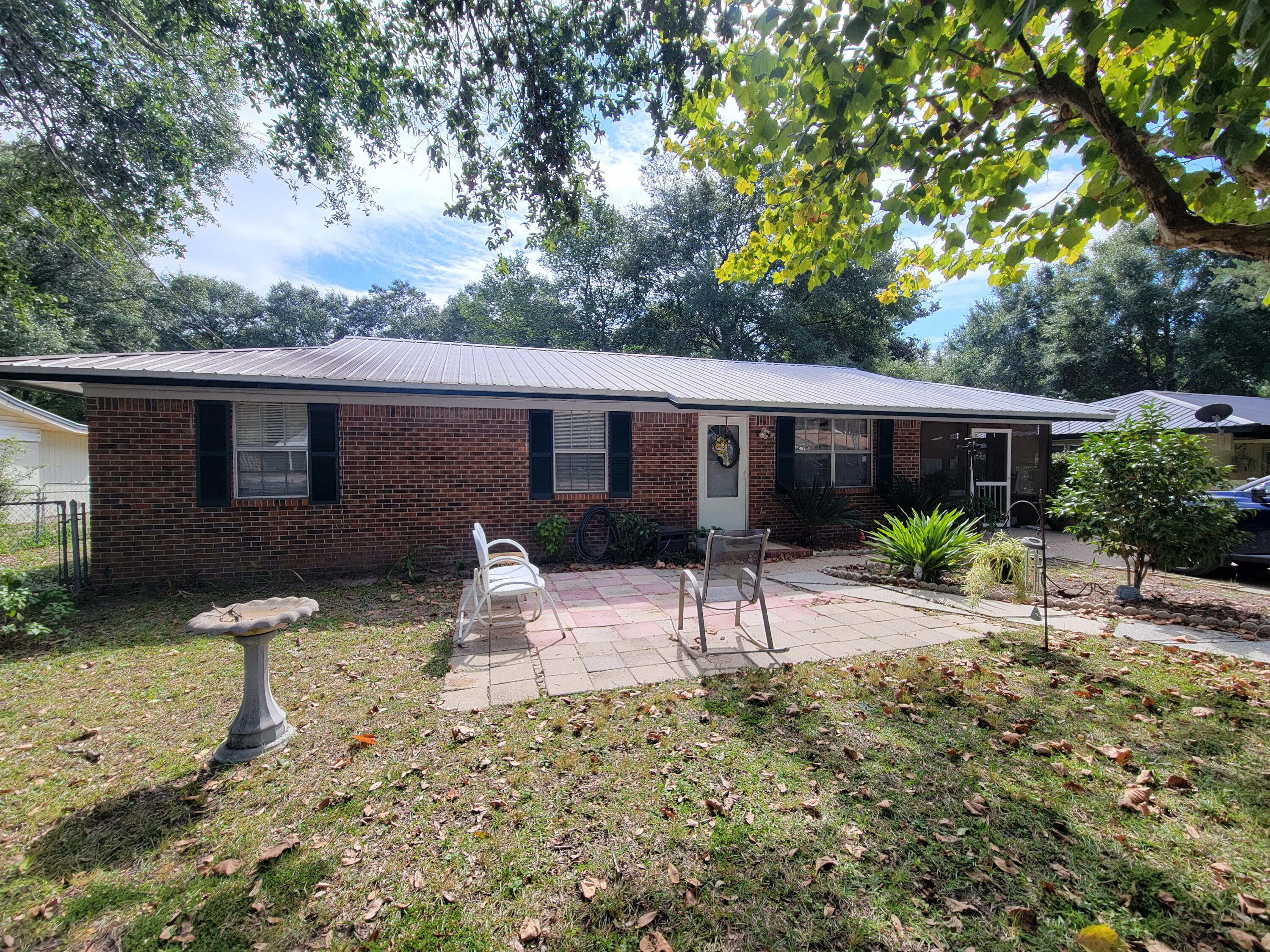 It just feels like home! This well built brick home has a metal roof (2013) and a yard that feels like 'family get-togethers' front and back. Kitchen has lots of cabinets and the dining area is large enough for full size table and accessories. Three bedrooms and 1 bath. The carport is screened in to enjoy the mornings and late evening family and friends. The back yard is fully fenced and has a sweet garden spot to grow your own vegetables plus a must-have utility building. Property is in the city limits just off Hwy 331 N.