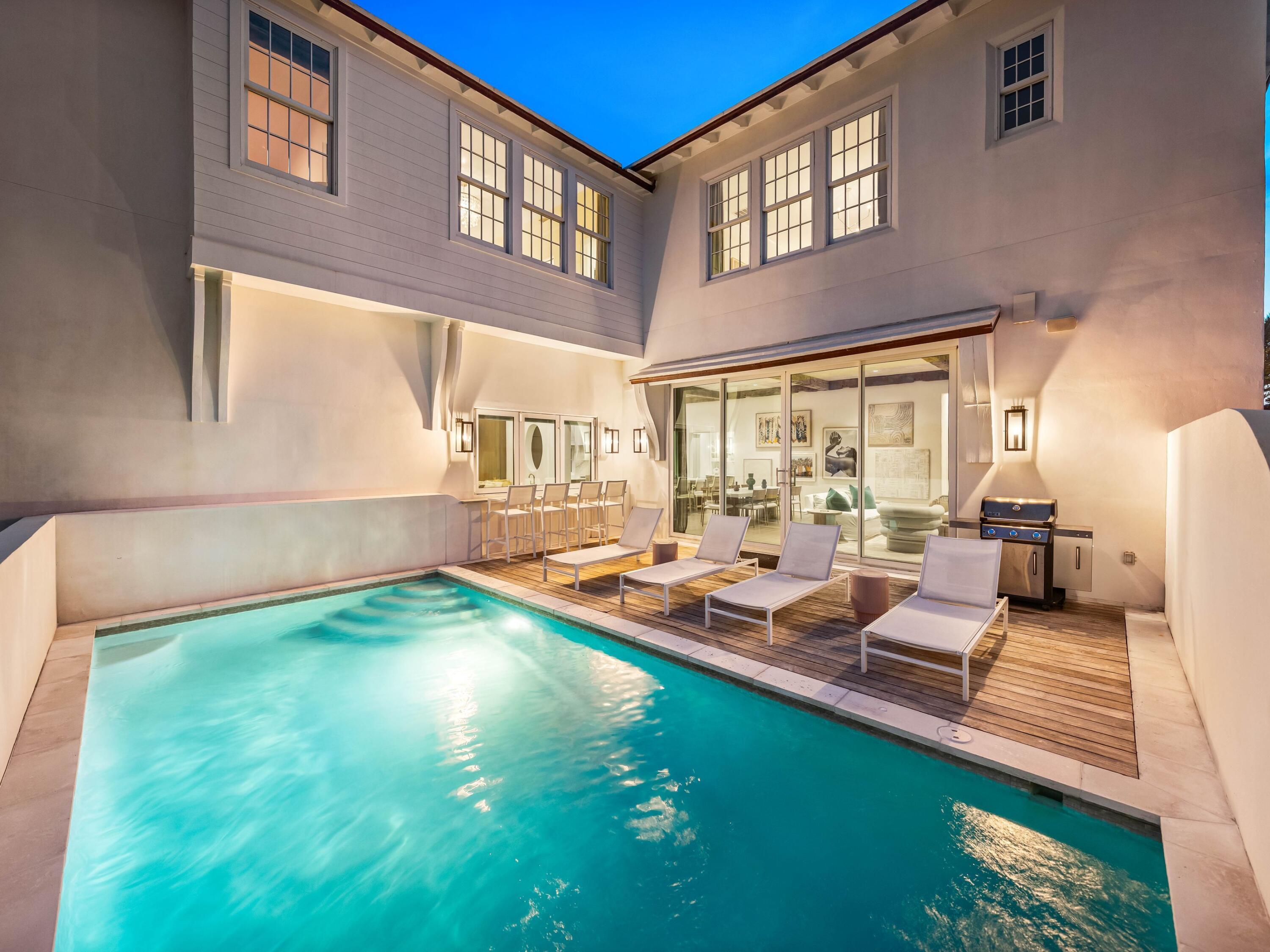 Welcome to Santimo Beach, where this 5,976 square-foot residence is among 20 exclusive properties. The home's three elevator-accessible floors accommodate five bedrooms, a bunk room, five full bathrooms, and a powder bath. A staircase connects the third level to the tower, which offers panoramic views of the Gulf waters. Two king-size bedrooms, one with an ensuite bathroom, along with a bunk room, separate a guest bathroom, and a laundry room join an oversized two-car garage with a Tesla charging station on the ground floor.The emphasis on indoor-to-outdoor living is evident once you walk upstairs, where an open-concept living area connects to an elevated deck featuring chaise lounges and a heated pool. Accordion windows fully retract at the outdoor bar, creating a pass-through between between the pool deck and a casual dining area with a wet bar. Designer cabinets conceal a range of gourmet kitchen appliances, including a Liebherr refrigerator, Thermador freezer, and Asko dishwasher. Luxurious marble accents and a custom vent hood highlight the Wolf range. A waterfall countertop serves as a striking centerpiece on the kitchen island, with bar seating that transitions to an additional dining space.
The nearby scullery neatly contains another Asko dishwasher, beverage center and wet bar. The second floor concludes with the powder bath, a media room and a double queen-size ensuite bedroom. An additional living area on the third floor creates a total of three distinct living spaces for owners and their guests to enjoy. The grande primary suite includes a luxurious bath retreat featuring a walk-in shower and soaking tub plus spacious closet. A separate light-filled room is the perfect spot for an office or yoga studio. An additional king-size ensuite plus the second laundry room complete this level. This residence boasts multiple living areas, a pool deck meticulously designed for entertaining, elegantly appointed bedrooms, and a prime location within one of the most secluded gulf-front enclaves on 30A. Within its vicinity, you can enjoy both grandeur and functionality, conveniently situated just a short distance from the pristine beach. Santimo Beach is a gulf-front community that is surrounded by the vibrant new urbanism communities of Rosemary Beach and Alys Beach. This gated retreat provides its residents with an unparalleled level of privacy amidst the vibrant social scene that permeates the nearby town centers. These town centers offer a diverse array of shops, restaurants, and events, catering to the diverse interests of their residents.