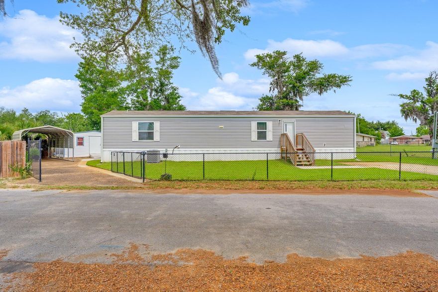 Welcome to this beautifully maintained 2-bedroom, 2-bathroom manufactured home, built in 2023 and situated on nearly a quarter-acre corner lot. Nestled among mature trees, this property offers the perfect blend of modern living, outdoor space, and a prime location. Step inside to an inviting open-concept main living area, ideal for entertaining or relaxing with family. The bright, functional layout offers comfort and style in every room. Outside, enjoy the convenience of two large storage sheds, a private irrigation well for easy lawn and garden care, and a fully fenced yard with durable chain-link fencing--perfect for pets, kids, and outdoor gatherings. Located just a short stroll from John B Gore Park and less than a quarter mile from the Bay and public boat ramp.
