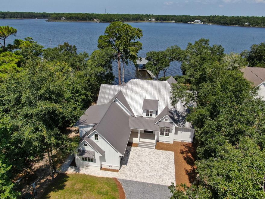 Introducing a brand-new custom waterfront home on the coveted Lagrange Bayou. This beautiful home is situated on a large private .79 acre lot with 108 feet of deep water bayou frontage that is navigable to the bay and the Gulf of Mexico. A covered boat dock with lift easily accommodates up to a 23' boat. The main level features 3 bedrooms, each with full baths as well as an office/4th bedroom.  Upon entering the home, you are greeted by 16' vaulted cathedral ceilings and oversized sliding glass doors providing an unparalleled view of the water. You'll enjoy amazing sunsets throughout the house as well as from the large rear patio.