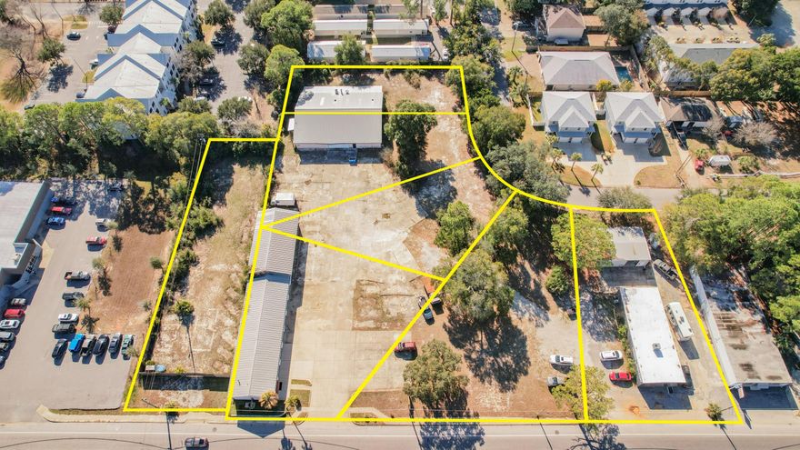 This offering is a rare legacy property assemblage consisting of seven combined parcels located at 16 and 20 Hollywood Boulevard in the southeast area of Fort Walton Beach, Florida, totaling approximately 2.77 acres with over 400 feet of frontage along Hollywood Boulevard and additional rear access from Park Circle / Park Place. The site is strategically positioned less than one mile from U.S. Highway 98 and approximately one-third of a mile from Eglin Parkway's primary commercial corridor, providing excellent visibility and access. Improvements include four buildings totaling approximately 13,513 square feet, featuring multiple auto service bays, storefront/shop space, warehouse and storage buildings, lobby and office areas, and a large privacy-fenced laydown yard of approximately 1.61 acres, ideal for outside storage or parking. Zoned MX-2 (Mixed-Use High), the property has supported long-standing local businesses for decades; the former Tona's Auto Center facilities are now vacant, while Haudini Upholstery remains in operation, making the assemblage well-suited for an owner-user seeking scale, continued automotive or commercial use, or a future redevelopment opportunity in a high-demand corridor.