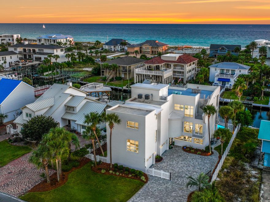 NEW LISTING! Welcome to 612 Magnolia Drive, an exceptional waterfront estate perfectly positioned on the deep waters of Scenic Harbor in Holiday Isle, Destin, Florida. This furnished canal-front residence yields 6,000+/- square feet of luxurious living space, 4-bedrooms, 4.5- bathrooms, and an extraordinary combination of design, quality, craftsmanship, and functionality. The expansive open-concept layout is enhanced by soaring ceilings and floor-to-ceiling windows that illuminate the residence with natural light while experiencing the breathtaking waterfront vistas. Interior features include an elevator, dual laundry rooms, quartz countertops, custom cabinetry, Viking appliances, automated window treatments, Kinetico water softener, reverse osmosis drinking system, and tankless water... heaters. The outdoor living area offers generous entertaining spaces, a synthetic dock with 16,000-pound boat lift, and saltwater pool with heater that seamlessly blend indoor comfort with waterfront enjoyment. The rooftop deck, accessible by both elevator and spiral staircase, captures breathtaking 360-degree panoramic views of the Gulf of America, Destin Harbor, Intracoastal Waterway, and Choctawhatchee Baythe perfect vantage point for year-round sunrises and sunsets. Residents of Holiday Isle enjoy two private deeded beach accesses, low annual association dues, and a lifestyle defined by convenience and proximity and access to sugar white sand beaches, world-class boating, fishing, dining, and shopping along the Emerald Coast of Northwest Florida. Please note documents available under the "Documents" tab. Schedule your private showing today!