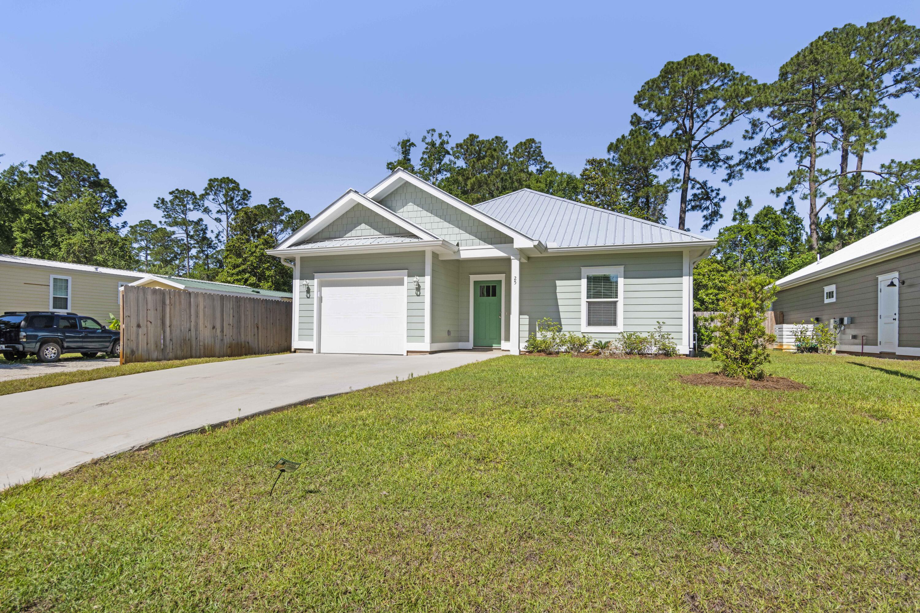 Beautiful newly built home just a few minutes from the nearest beach access and to the bay. Pull into the driveway with a single car garage and plenty of space to park 3 additional cars. This adorable 3-bedroom one story residence was thoughtfully built with 3 feet of elevation above street level and a metal roof and gutters. Step inside the wide entry way and onto the luxury vinyl plank floors and pass by two spacious bedrooms and a full bath with a tub/shower combo. Enjoy the perks of a separate laundry room with a washer and dryer that convey.