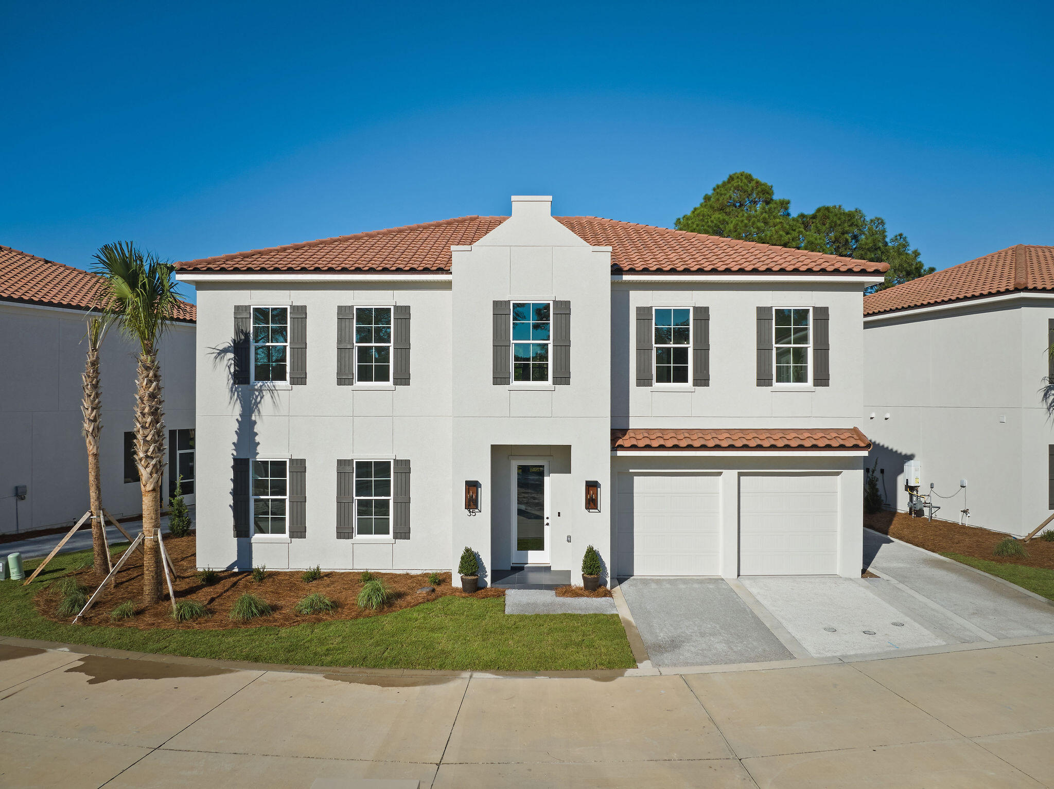 Experience luxury living at its finest in the brand-new 2023 custom home located in the Grand Villas community within the gated community of Tops'l Beach and Racquet Club. This stunning 3,534 sq. ft. residence, one of just 15, offers sophistication and elegance with an open design, high ceilings, and abundant natural light streaming through its many windows. The living area features charming tongue- and- groove ceiling and a gas fireplace, creating a  ambiance for relaxing evenings. The kitchen is a chef's dream, boasting premium Viking stainless steel appliances, custom cabinetry, sparkling quartzite countertops and backsplash, and a spacious breakfast bar, perfect for entertaining. The home offers four spacious bedrooms, including two luxurious master suites-one on the main level and the second upstairs. Each master suite features en suite bathrooms with double vanities and quartz countertops. Two additional guest bedrooms and bathrooms, plus a media room that can double as an extra bedroom, ensure there's ample space for family and guests. Thoughtful upgrades include a convenient elevator providing easy access to both levels, dual laundry rooms on each floor, and a screened patio with built-in grill, ideal for outdoor dining. Upstairs, a sitting area with wet bar is perfect for cocktails or snacks, while the media room enhances the homes entertainment options. The climate controlled two-car garage and three additional driveway parking spaces offer ample room for vehicles. As part of Tops'l Beach and Racquet Club, residents enjoy private beach access, a full-scale tennis resort with 12 Rubicon courts, state of the art fitness center, multiple pools, and indoor pool, a pool with bar and restaurant, racquetball, steam room, sauna, and beautifully maintained common spaces. Schedule your private showing today and experience the ideal blend of luxury, convenience, and resort living!            