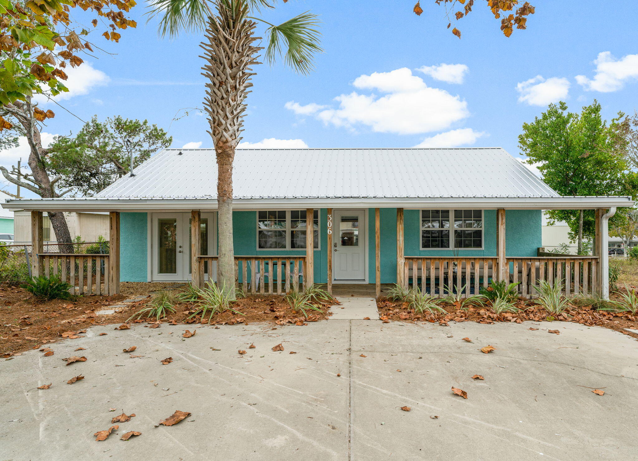 Welcome to 306 Malaga Place! This completely renovated 2 bedroom 2 bathroom 1205 square foot property is a must see!! The home includes a very detailed list of updates. A 2022 metal roof, new gutters, all new plumbing connected to city water/sewage, new electrical throughout, 2021 water heater, exterior paint, and ALL interior is brand new! New toilets, bathroom vanities, tile shower, LVP floors, kitchen cabinets, granite counters and so much more! Also includes a brand new stainless steel kitchen appliance package AND a brand new stackable washer & dryer. This property also includes over 300 square feet of covered front porch living, located just 3 blocks up from the beautiful beaches! This is the perfect vacation home or short term rental to add to your portfolio!