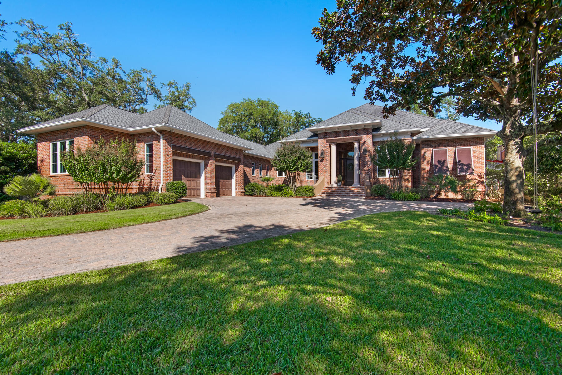 The wait is OVER! 100 feet of waterfront living with spectacular views and luxury finishes!! Welcome home to 17 SE Bay Drive! This impeccably maintained single level home boasts close to $200k in recent upgrades and improvements. The beautiful front yard begins the tour of this traditional brick home, built in 2009, and nestled on over half acre. The oversized paver driveway creates room for extra parking and leads into the side entry super-sized garage - with room for 2 cars and much more! Enter through the covered front porch with gas lanterns & beautiful front door to tile flooring, soaring ceilings, and custom light fixtures. Through the large foyer, you enter a stunning sitting room with paneled ceilings and access to the other areas of the home. The comfortable family room features