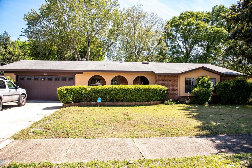 Great curb appeal at this beautifully maintained, mostly original home. Completely rewired with new breaker panel installed, new ceiling fans, light fixtures and smoke detectors. Oversize garage has wrap around workbench with electrical outlets. Separate mudroom/laundry room opens to fenced in back yard featuring a two tiered deck with benches, perfect for entertaining. Jasmine vines scent the air, covering the pergola providing shade. Bring those freshly grilled steaks through the sliding doors into the dining and living area, with the kitchen just steps away. Typical ranch style layout of bedrooms and bathrooms keeps everyone close enough to check on in the middle of the night. Carpeted living areas and bedrooms with tile and vinyl in the wet areas. Cox Homelife security system installed