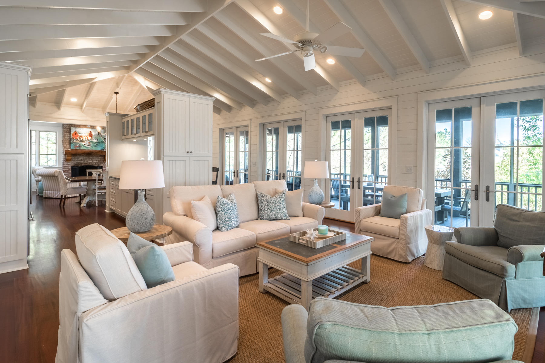Generous screened-in porches wrap this custom built, four bedroom home found on an oversized lot across the street from Camp WaterColor on the corner of Spartina Circle and Pond Cypress Way. Boasting 1,300 square feet of wraparound, screened in porches on both levels and a spacious brick paver patio with an outdoor fireplace and summer kitchen, this two-story home is the perfect family beach escape. Kick back and relax on the screened porch's cozy outdoor furniture as you watch your children laugh and play at Camp WaterColor, or grill out with the family fireside in the courtyard and enjoy the mild Florida evenings. The porches are quite inviting and functional for families, and the courtyard offers comfy seating centered around a fireplace to create an outdoor living area