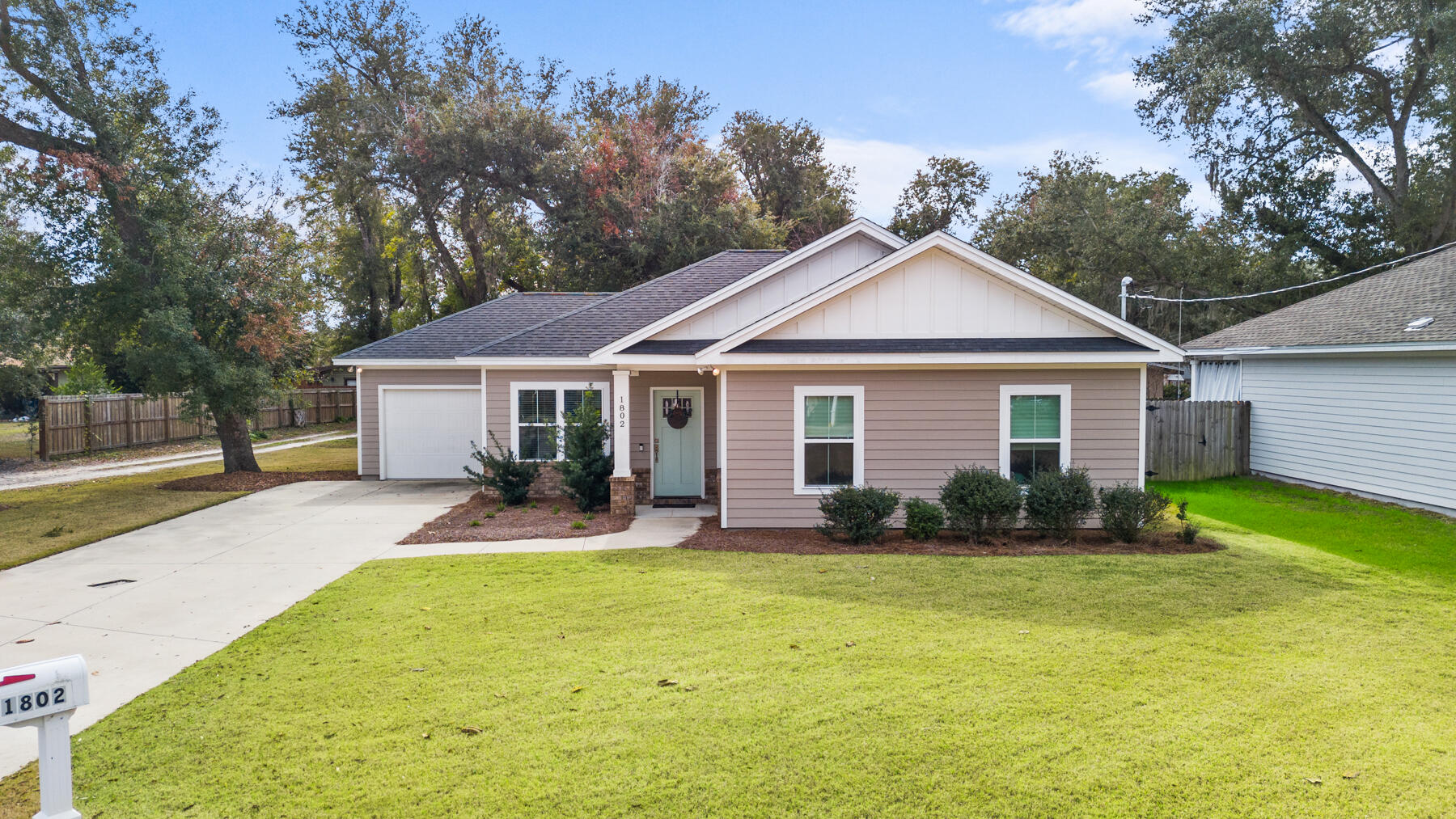 Looking for charm AND a newer construction in the historic Cove neighborhood with NO HOA? It does exist! Enjoy a cozy, craftsman-style Cove bungalow situated in the heart of Panama City, Florida. This single-level 2021-built home offers 1,459 square feet of living space, featuring 3 bedrooms, 2 bathrooms, and a 1-car attached garage. Designed with an open concept and rare 9-foot ceilings throughout, this residence exudes a tasteful design with a thoughtful floorplan.Upon entering the front stoop, you are greeted by high ceilings that seamlessly flow throughout and you're welcomed into the living room, dining and kitchen. The modern white shaker cabinetry and quartz countertops define the kitchen and the dining room offers large windows that let natural light flood through. You'll enjoy acess to the cozy covered back patio from the kitchen area and a generous sized yard with alley access. The split floor plan ensures privacy, with the primary suite thoughtfully positioned to overlook the shaded backyard. The primary suite boasts a large bedroom, double vanities, a tiled shower, and a sizable walk-in closet, providing a private retreat within the home.

The exterior of the property is clad with durable Hardie board siding, offering both aesthetic appeal and lower insurance costs. The lush landscaping and the covered patio at the back of the home create an inviting outdoor space perfect for relaxation outdoors. Alley access adds to the convenience and charm of this property allowing you to park additional vehicles on your property. 

Located in the desirable Cove neighborhood, the Cove community is adjacent to Downtown Panama City and the home is directly across from the Bay. The neighborhood is shaded by hundred-year-old oak tree-lined streets and features a new multi-use path that leads directly to Downtown. Here, residents can enjoy a variety of restaurants, shopping, farmers markets, festivals year-round, and breweries. The Cove is a no-HOA community, adding to the appeal of this location! 

For outdoor enthusiasts, a boat ramp is less than a mile from your front door, and the Cove offers multiple playgrounds and city parks, many of which overlook the beautiful Bay waters. Whether you prefer walking or biking, the multi-use path provides easy access to some of the best sunsets Panama City has to offer. Don't want to walk or bike? Hop on your golf cart in this golf cart-friendly community! 

Experience worry-free maintenance and modern living in this newer home, perfectly situated in a charming and vibrant community. Discover all that 1802 Tyndall Drive in the Cove has to offer!