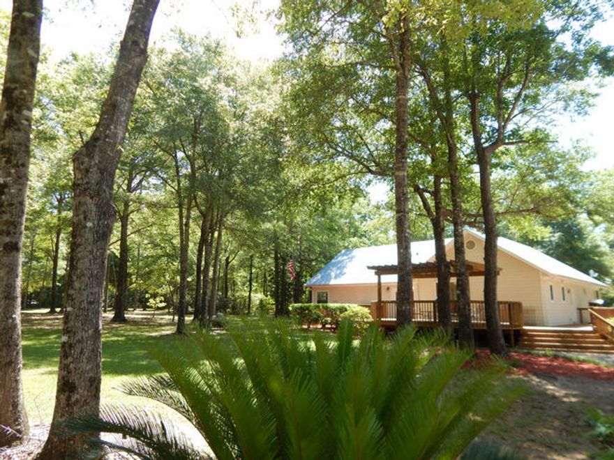 If you are looking for an absolutely beautiful country setting and a classy Craftsman style farm home, look no further, you just found it. Nicely secluded in a park like setting with a smooth black top road all the way, this property is a rare find. There is about 2 acres cleared for the home, the kids and outbuildings and the rest is in lush timber and wildlife. Inside the home you will find rustic, solid wood floors, imported tiled floors, raised ceilings with crown molding and fresh paint in neutral colors. There are 3 bedrooms in a split bedroom floor plan and 2 and half bathrooms. The bathrooms are nicely updated with whirlpool tub, tiled floors and walls. The kitchen is open to the great room and dining area. All major kitchen appliances stay with the home as well. Great family home!