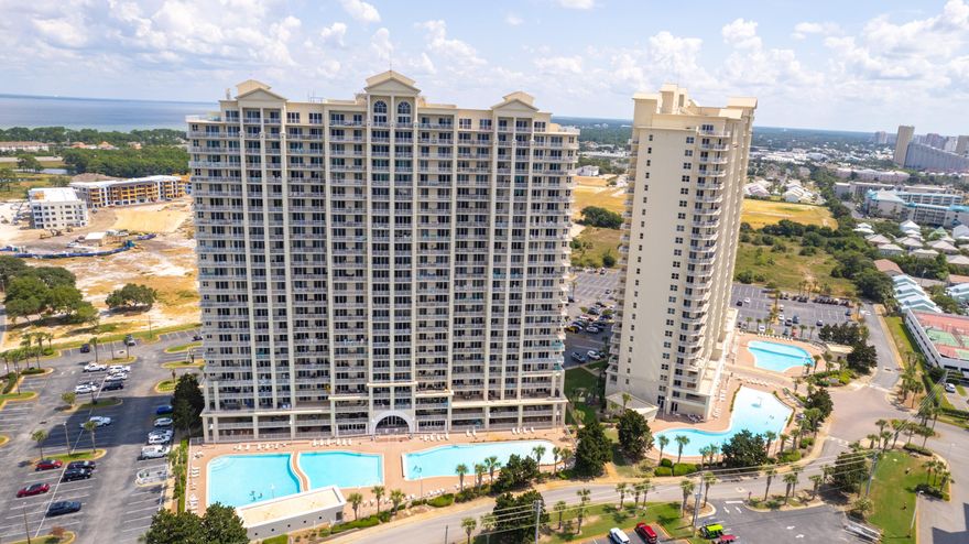 Spectacular panoramic views of the Gulf and Stewart lake from the 6th floor balcony. This unit is turn-key and furnished with great rental history. Glass sliders lead from both the living area and main suite to a large private balcony that also overlooks the beautiful pools.  The kitchen has granite counter tops, with a breakfast bar, stainless appliances, and a fun wallpaper backsplash to add color and style.  Fresh paint throughout, updated lighting, and refreshed decor! The view is protected by the historic Whale's Tail Beach Bar. Easy walk to the sand and water via the Stewart lake boardwalk or through the front gate. The complex offer multiple pools, fitness center, golf, tennis/pickleball facilities, conference center, and 2000 feet of beach front!
