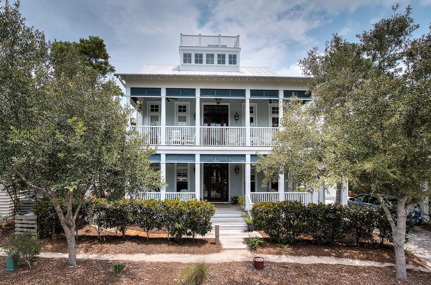 Commanding views of Western Lake, WaterColor, Seaside, and the Gulf are found atop this state-of-the-art 4,710 square foot Beach District home. Drawn by TS Adams, 445 Western Lake Drive is custom built with comfort in mind. Its location allows easy access to the beach and other neighborhood amenities; while it is in a very private area of the community. The 2nd floor living area, which includes an impressive gas burning fireplace and a separate media viewing room, is the perfect setting for a family gathering. The breakfast bar and large kitchen feature granite countertops and Dacor appliances. Each of the home's 5 bedrooms has an en suite bath, giving owners and guests added privacy and convenience. The master bath is divided into a his-and-hers layout, and features radiant