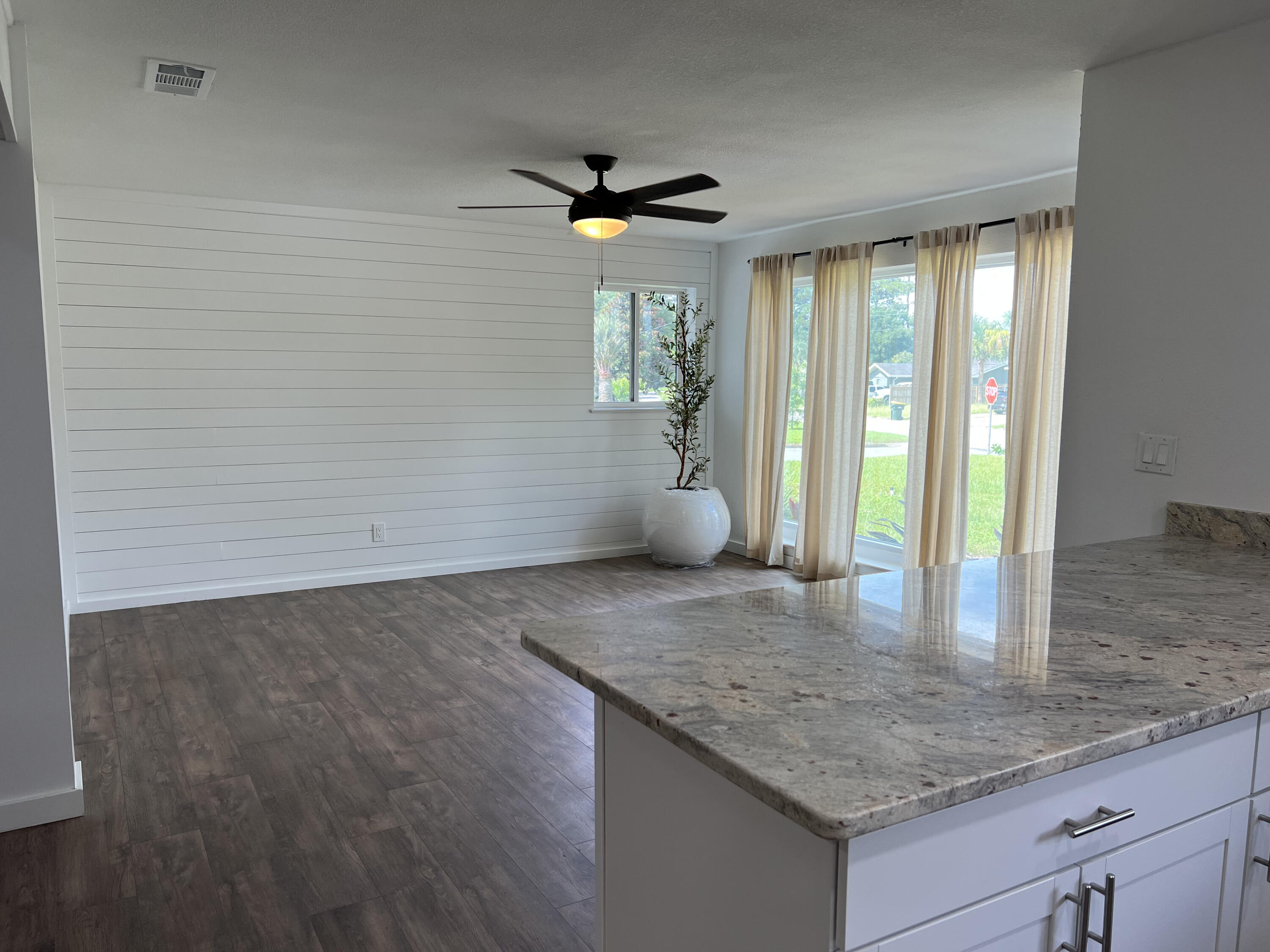 Perched high on a spacious corner lot, 47 Nebraska has been beautifully renovated to a sleek coastal design. Several fruit trees outline the property, which will provide for the years to come. The living room features a wood accent wall and massive floor-to-ceiling windows. The noteworthy kitchen features an enormous bar, custom crispy white cabinetry, granite countertops, a sleek backsplash, and all stainless steel appliances. The master bedroom also features a wood accent wall paired with an elegant barn door that leads to the massive walk-in closet. The master bath features double vanity sinks with sleek mirrors and lights, and the shower features floor-to-ceiling tile with a beautiful shower niche. The screened-in porch features a stunning stained wood ceiling and ceiling fan, perfect for outdoor entertainment. 47 Nebraska is next to the Patriots Trial, leading to the beautiful and active Ferry Park. The home is also in a prime location next to shopping, gyms, restaurants, and grocery stores.