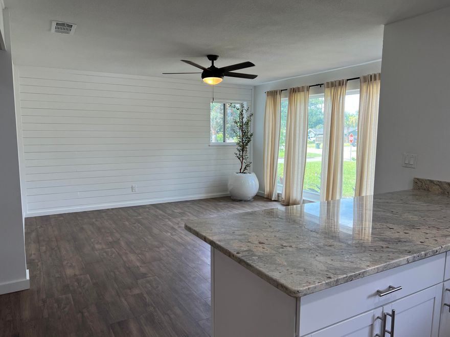 Perched high on a spacious corner lot, 47 Nebraska has been beautifully renovated to a sleek coastal design. Several fruit trees outline the property, which will provide for the years to come. The living room features a wood accent wall and massive floor-to-ceiling windows. The noteworthy kitchen features an enormous bar, custom crispy white cabinetry, granite countertops, a sleek backsplash, and all stainless steel appliances. The master bedroom also features a wood accent wall paired with an elegant barn door that leads to the massive walk-in closet. The master bath features double vanity sinks with sleek mirrors and lights, and the shower features floor-to-ceiling tile with a beautiful shower niche.  The screened-in porch features a stunning stained wood ceiling and ceiling fan, perfect for outdoor entertainment. 47 Nebraska is next to the Patriots Trial, leading to the beautiful and active Ferry Park. The home is also in a prime location next to shopping, gyms, restaurants, and grocery stores. 